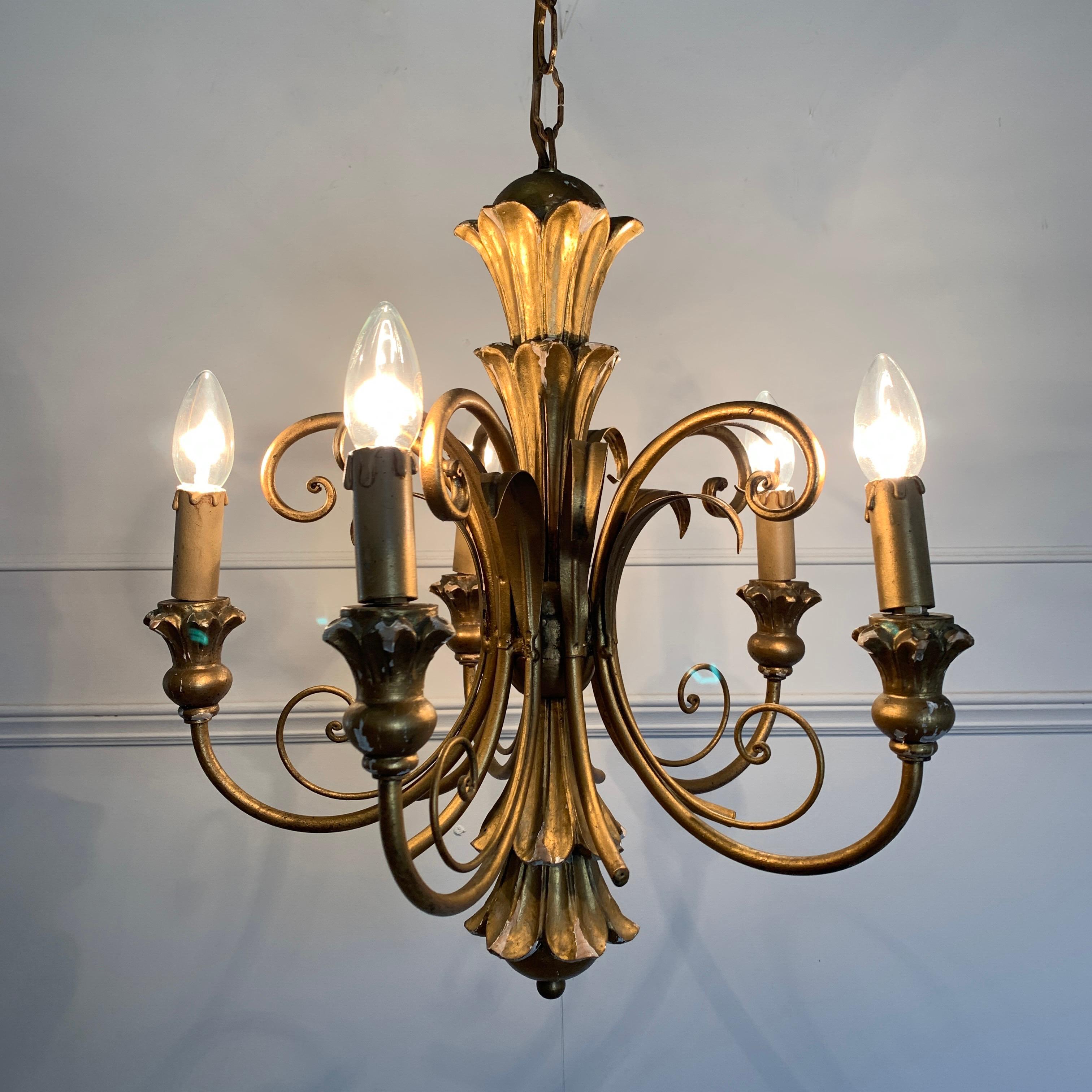 Italian giltwood scroll chandelier, circa 1960s
The carved wooden central finial is decorated with its gesso and gilt finish
Scroll wirework tendrils and metal arms reach out to the wooden lamp holders
There are 5 bulb holders, E14 small screw in