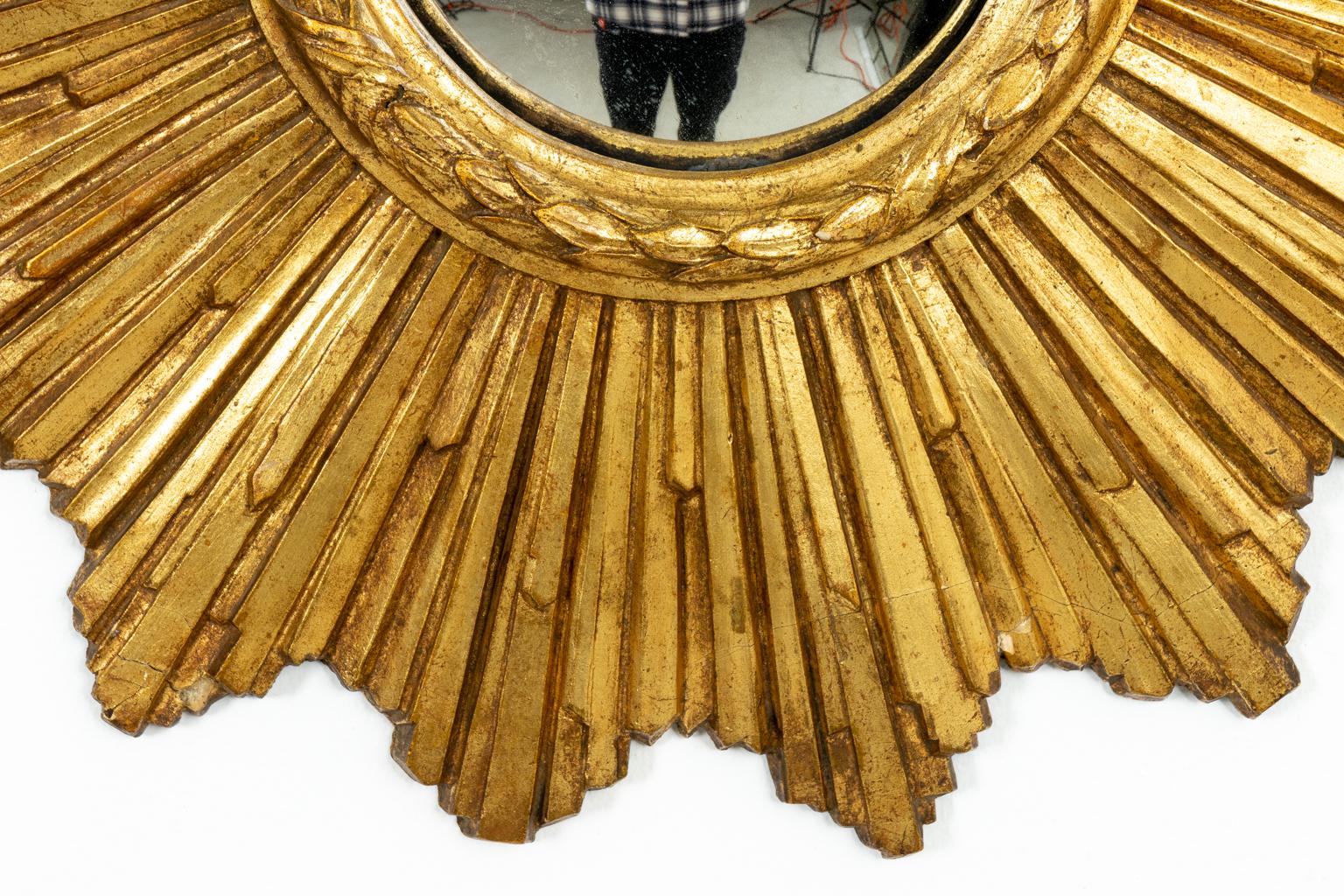 Giltwood starburst mirror, circa 1920s. Made in Italy. Please note of wear consistent with age including minor finish loss.