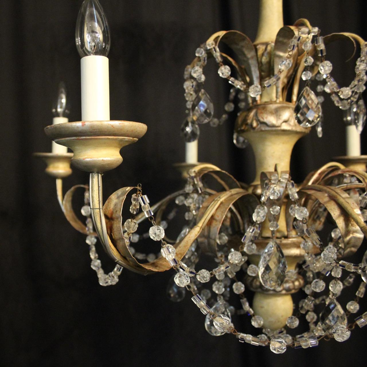 A decorative Italian giltwood and toleware 6-light antique chandelier, the silver gilded metal leaf scrolling arms with wooden bulbous bobeche drip pans, issuing from a cream painted wooden baluster knopped central column with floral silver toleware