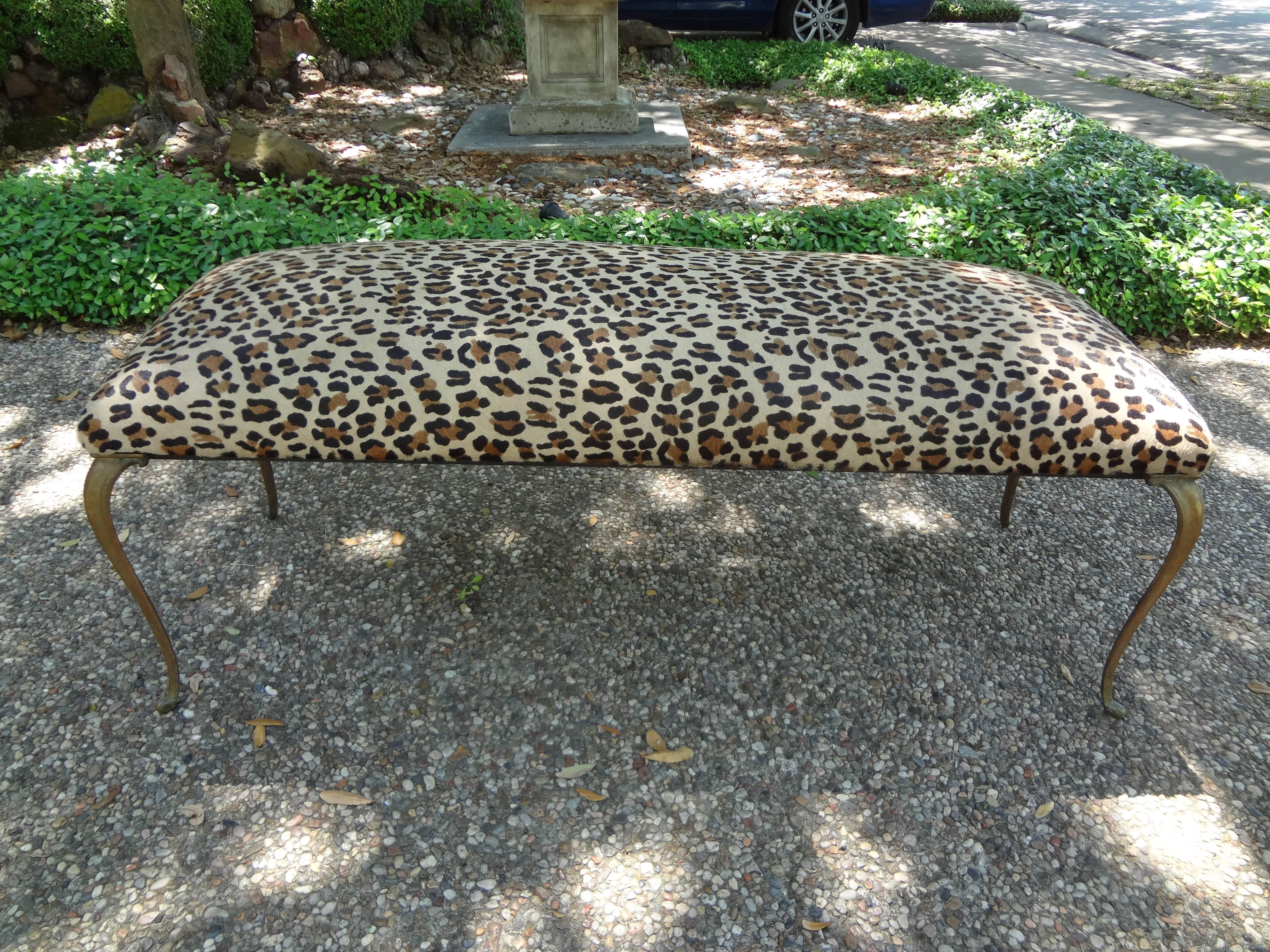 Stunning Italian Gio Ponti style brass or bronze bench professionally upholstered in superior quality Italian leopard print hair hide, circa 1960. Excellent patina to the finish.