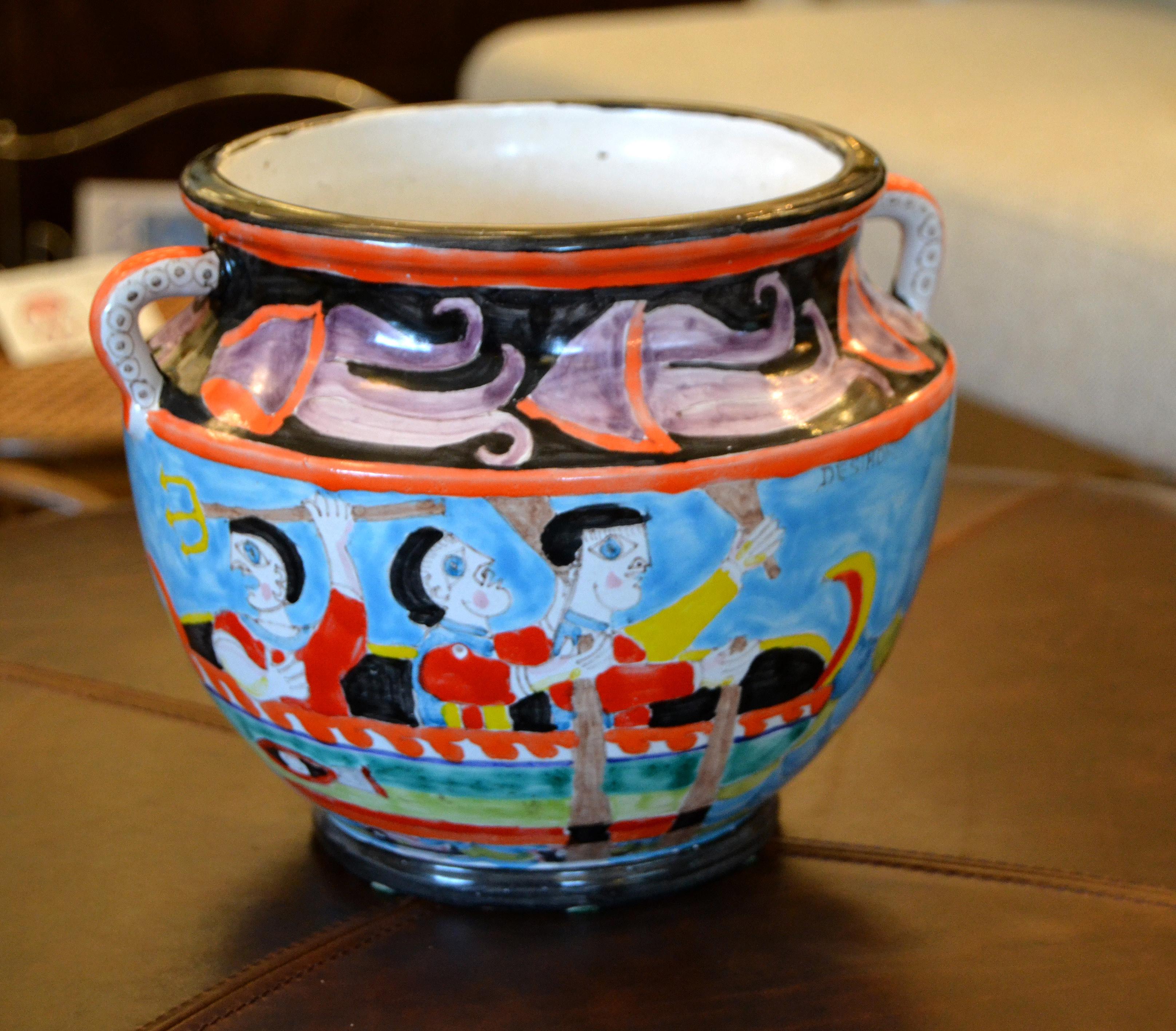 A glazed and colorful Giovanni De Simone hand painted pottery bowl, circa 1960 from Italy.
The painting depicts a number of fishermen on board a floating boat on the ocean catching several octopus and other fishes.
The bowl is 7.25 inches high and