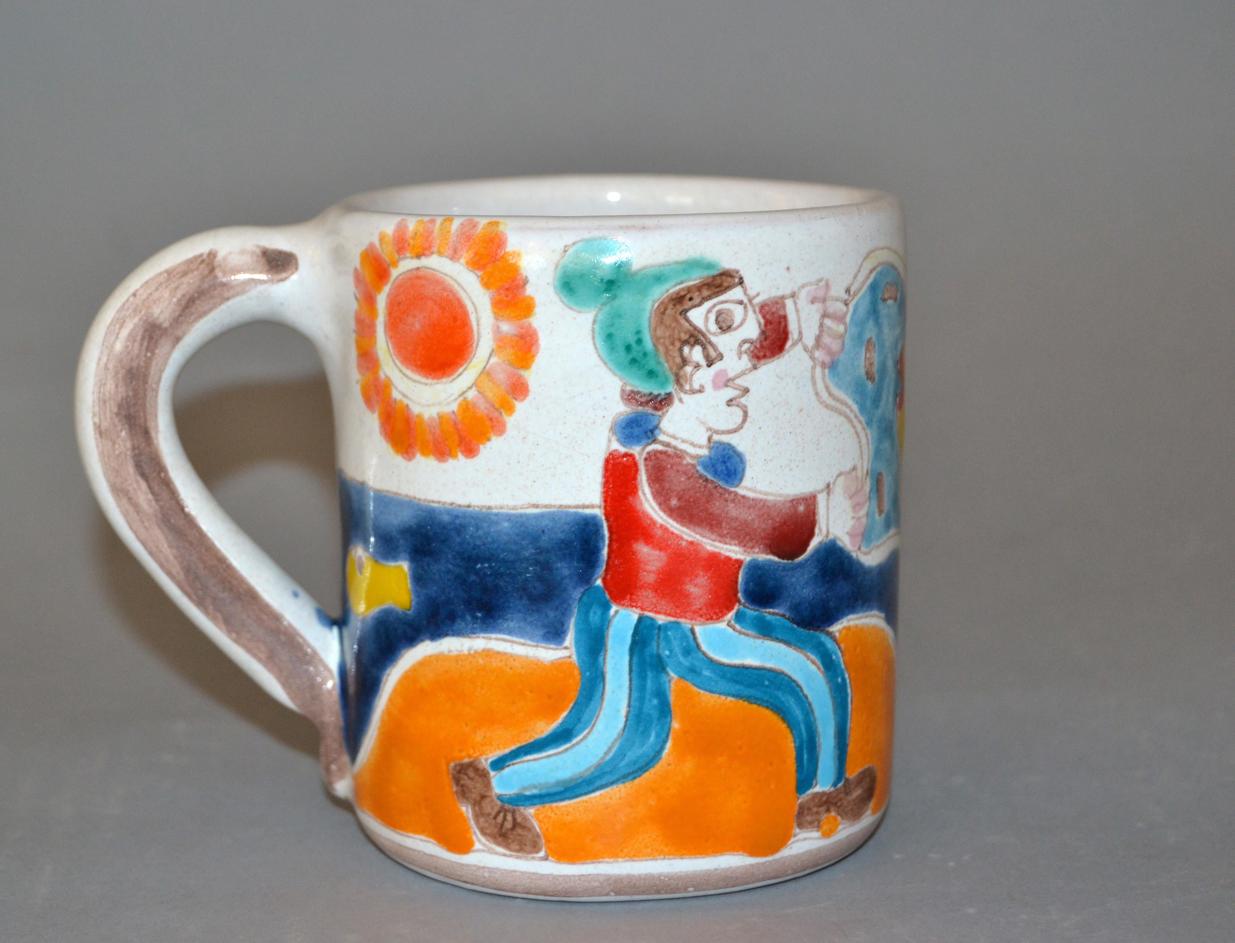 Original Italian Giovanni DeSimone hand painted art pottery, decor mug or cup with a scene of a fisherman casting his net and catching a family of fish on a sunny day.
The mug is glazed and very colorful.
DeSimone mark and numbered underneath,