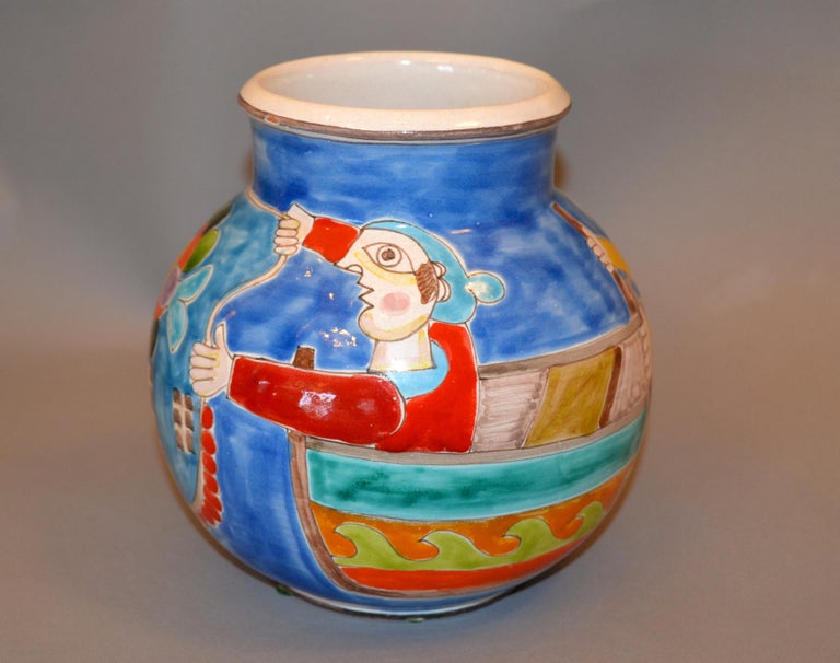 A glazed and colorful Giovanni Desimone hand painted pottery bowl from Italy.
The painting depicts two fishermen casting their bait nets to catch fish.
The bowl is 7.38 inches high and 7.5 inches in diameter and is in excellent condition with no