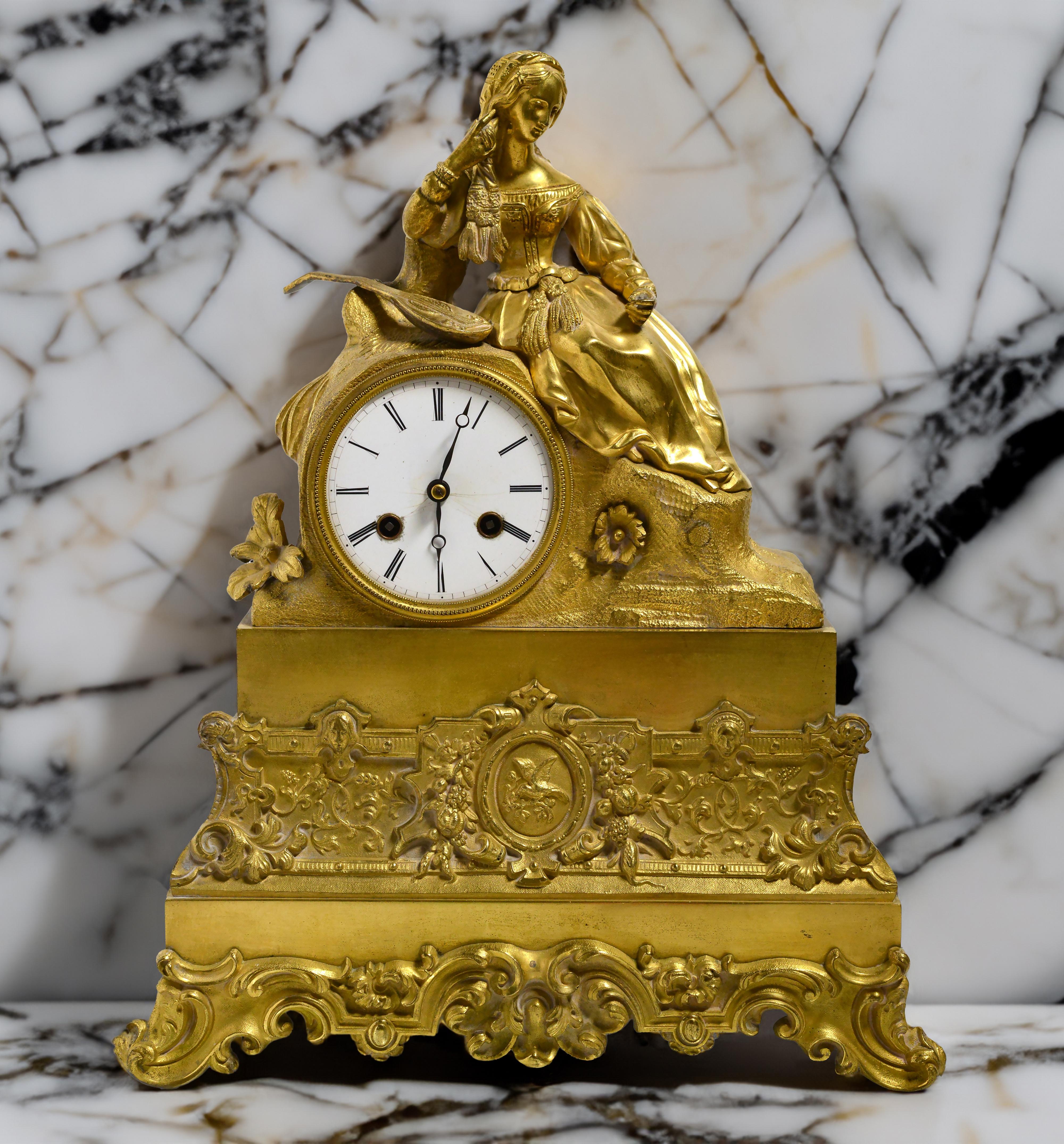 Fine work of gold-plated bronze as mantel (desk, shelf) clock. Italian A renaissance girl thoughtfully holds a strand of hair in a relaxed reclining pose. Antique French gilt bronze figural clock,19th century.
Size app.: 36 cm (roughly 14.2 in)