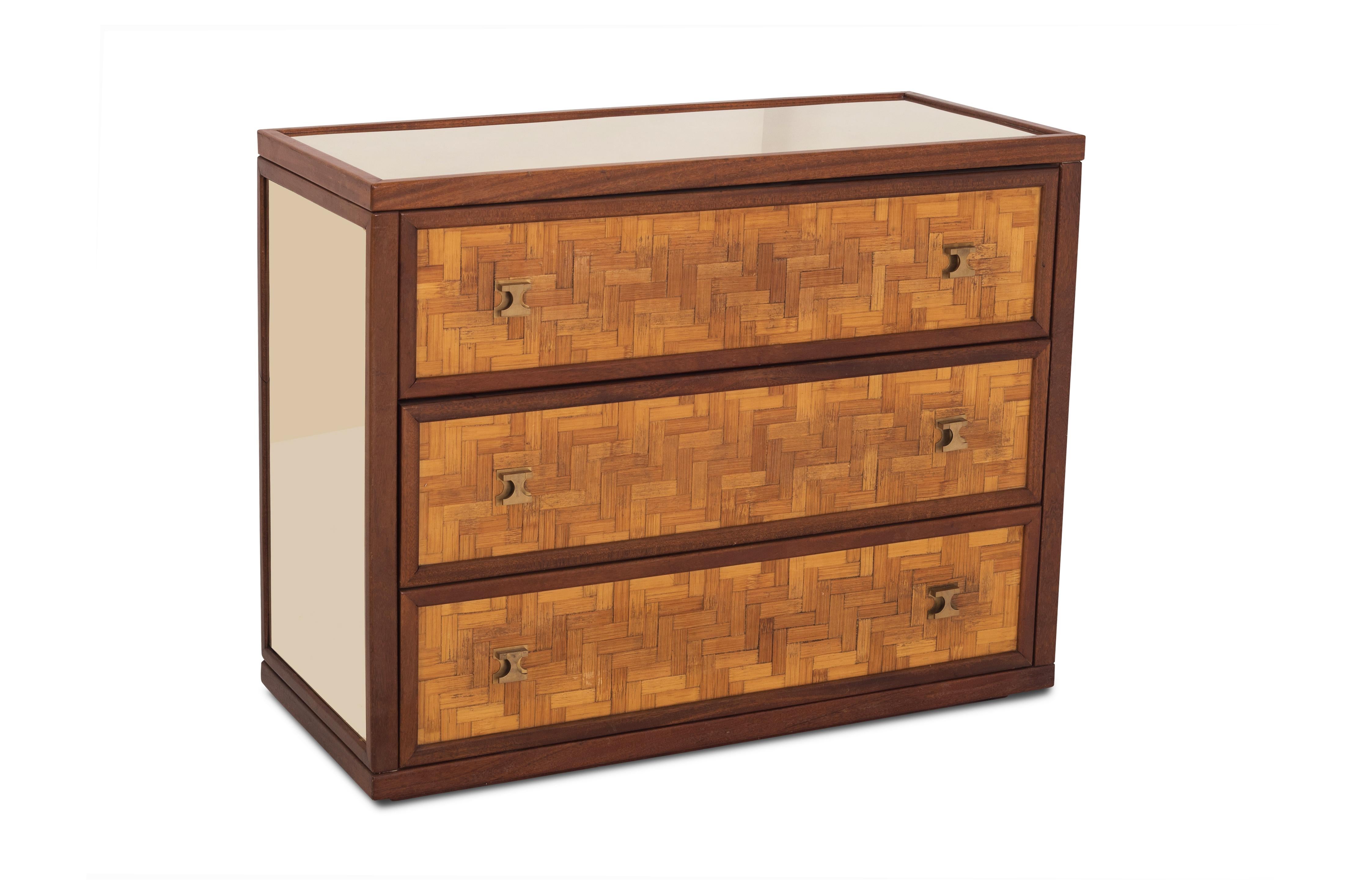 Teak sideboard in the style of Harvey Probber with reflecting brass side panels and top, equipped with three large rattan cladded drawers, providing plenty of storage space. The cabinet is finished with elegant brass handles.
