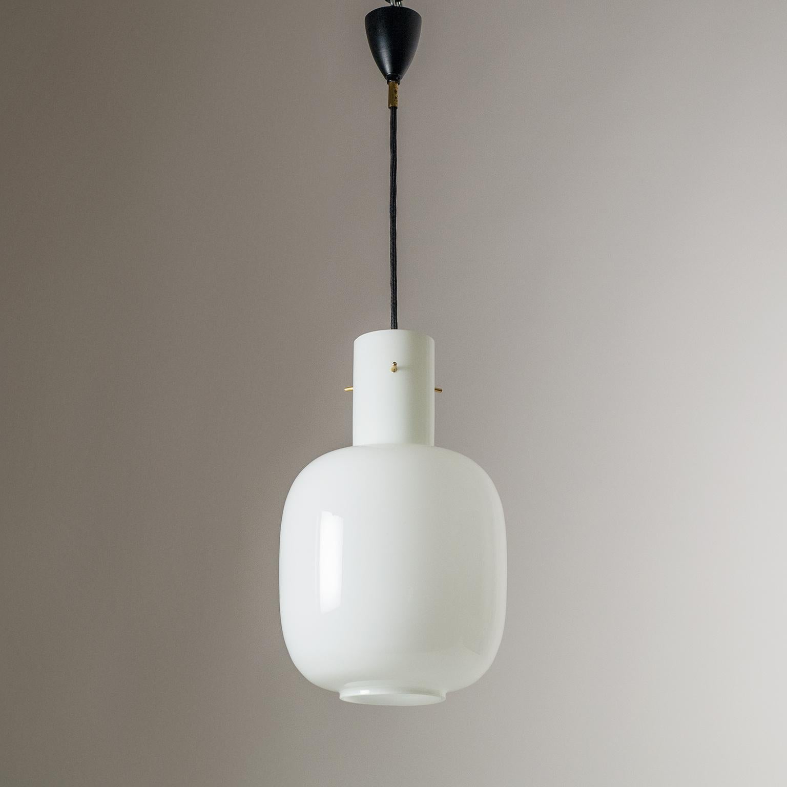 Modernist Italian glass pendant attributed to Stilnovo, 1950s. Nicely sized and proportioned glass body made of 'triplex opal' glass which is very typical of Stilnovo. The glass body is suspended by three brass stems. One original brass and ceramic