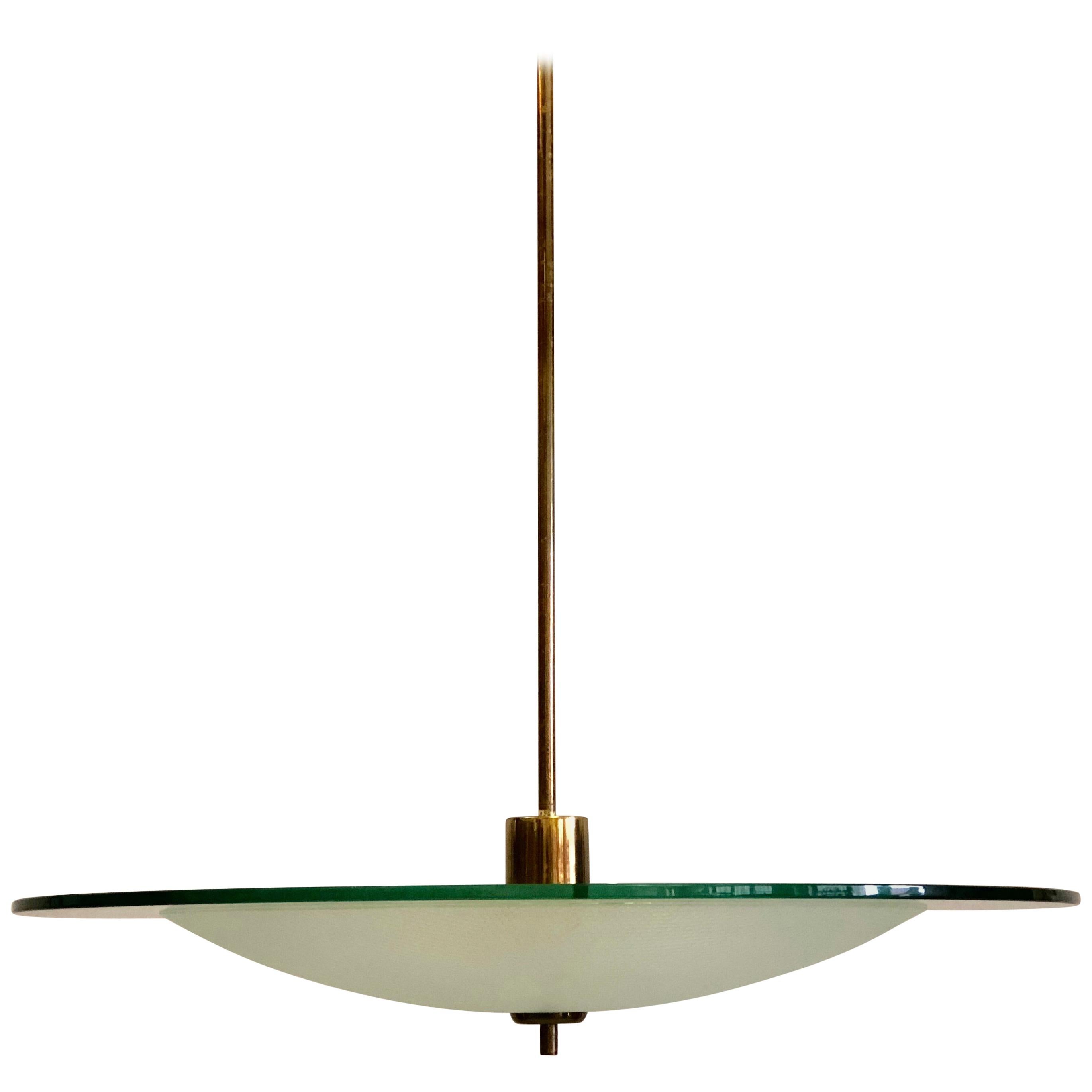 Large Italian Mid-Century Modern pendant or chandelier in glass and brass by Gio Ponti and Pietro Chiesa for Fontana Arte, Milan. 

The piece is composed of brass hardware and 2 glass reflectors. The central reflector is round curved opaque glass