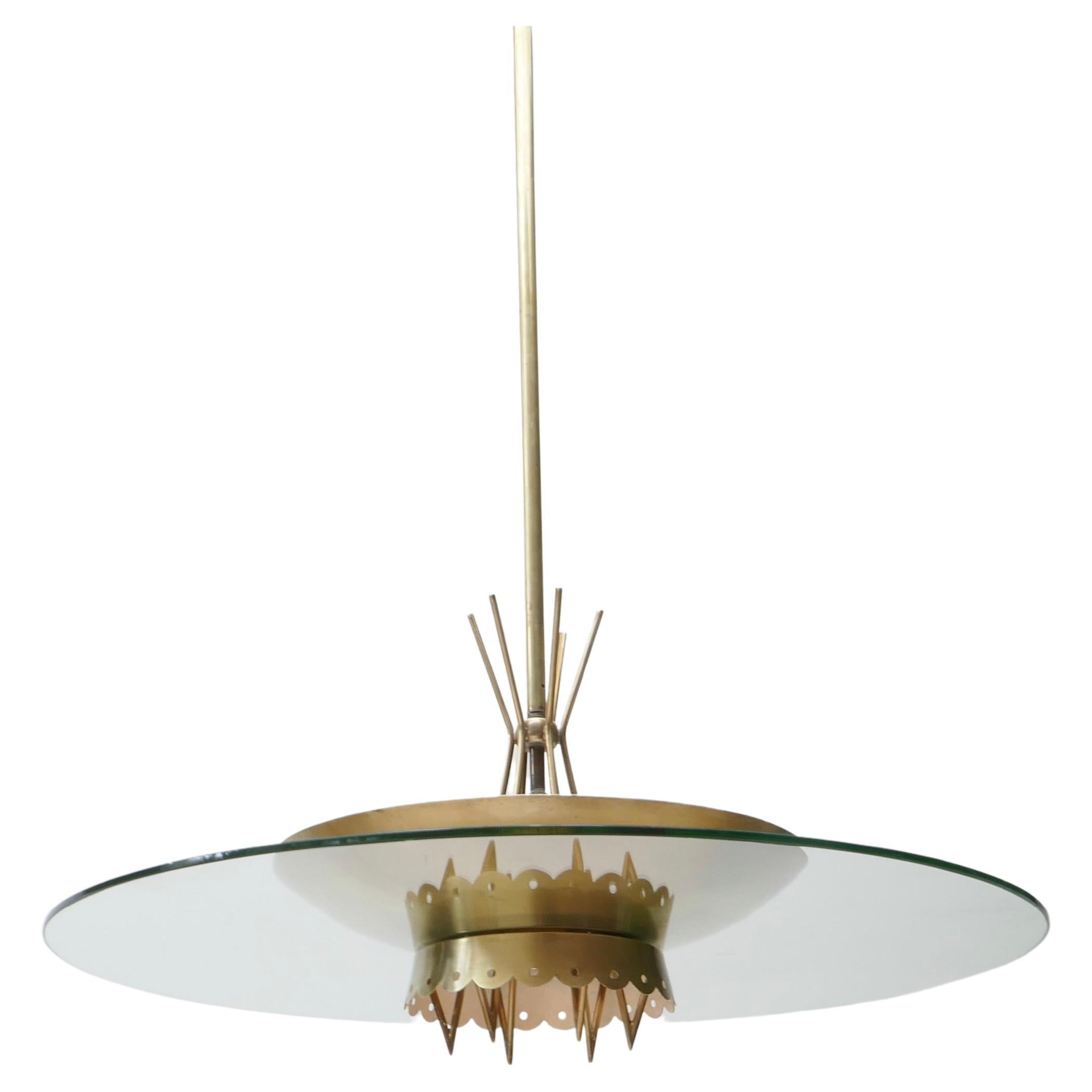 This saucer shaped chandelier is a typical expression of early 1950s Italian design in style of Fontana Arte style UFO chandelier. 
Top dish is clear glass. Artful brass details embellish the outer ring and the rod 
Total height is 94cm (