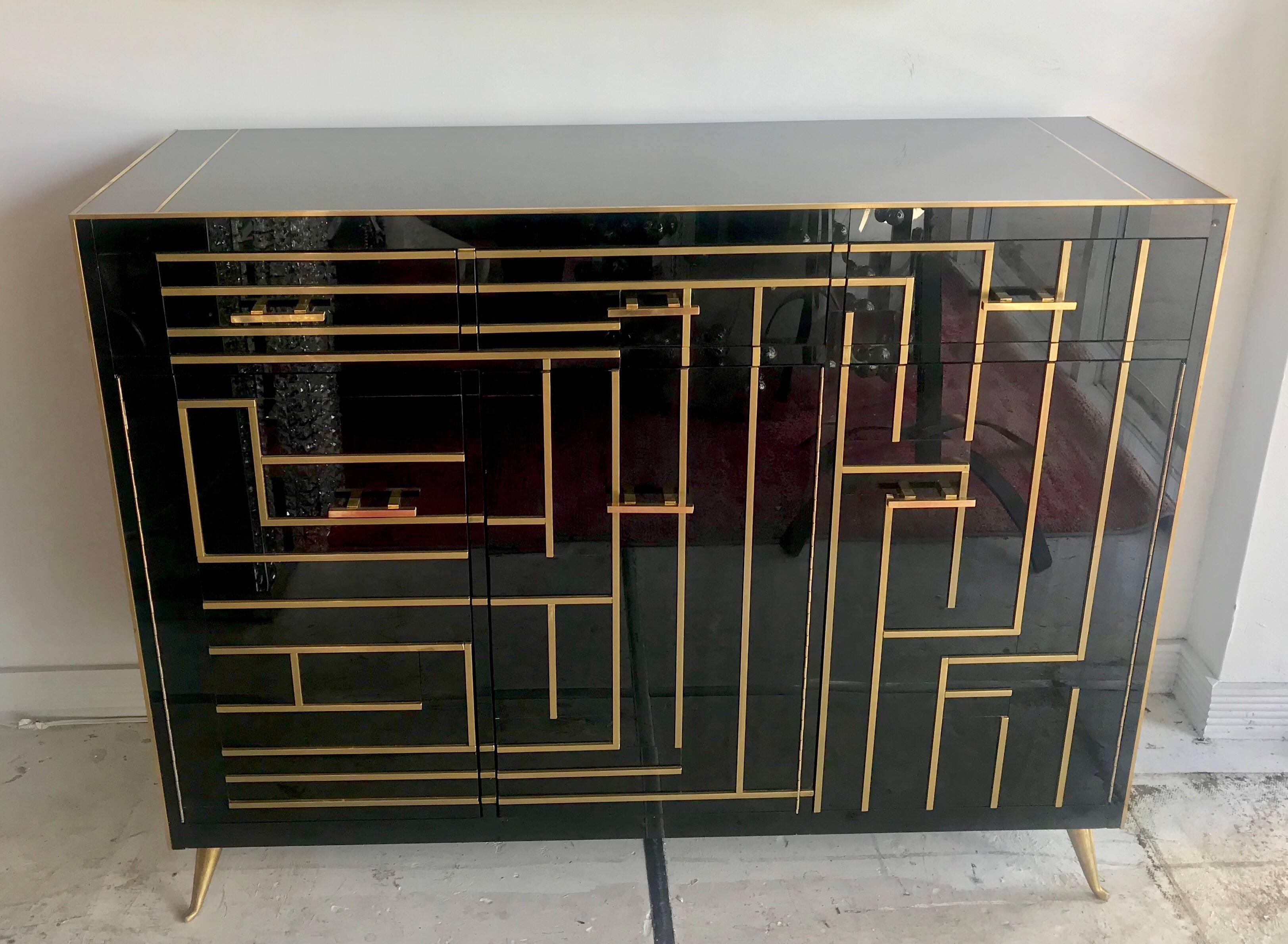 Beautiful Italian Murano glass and brass credenza/sideboard with three drawers and interior shelving.