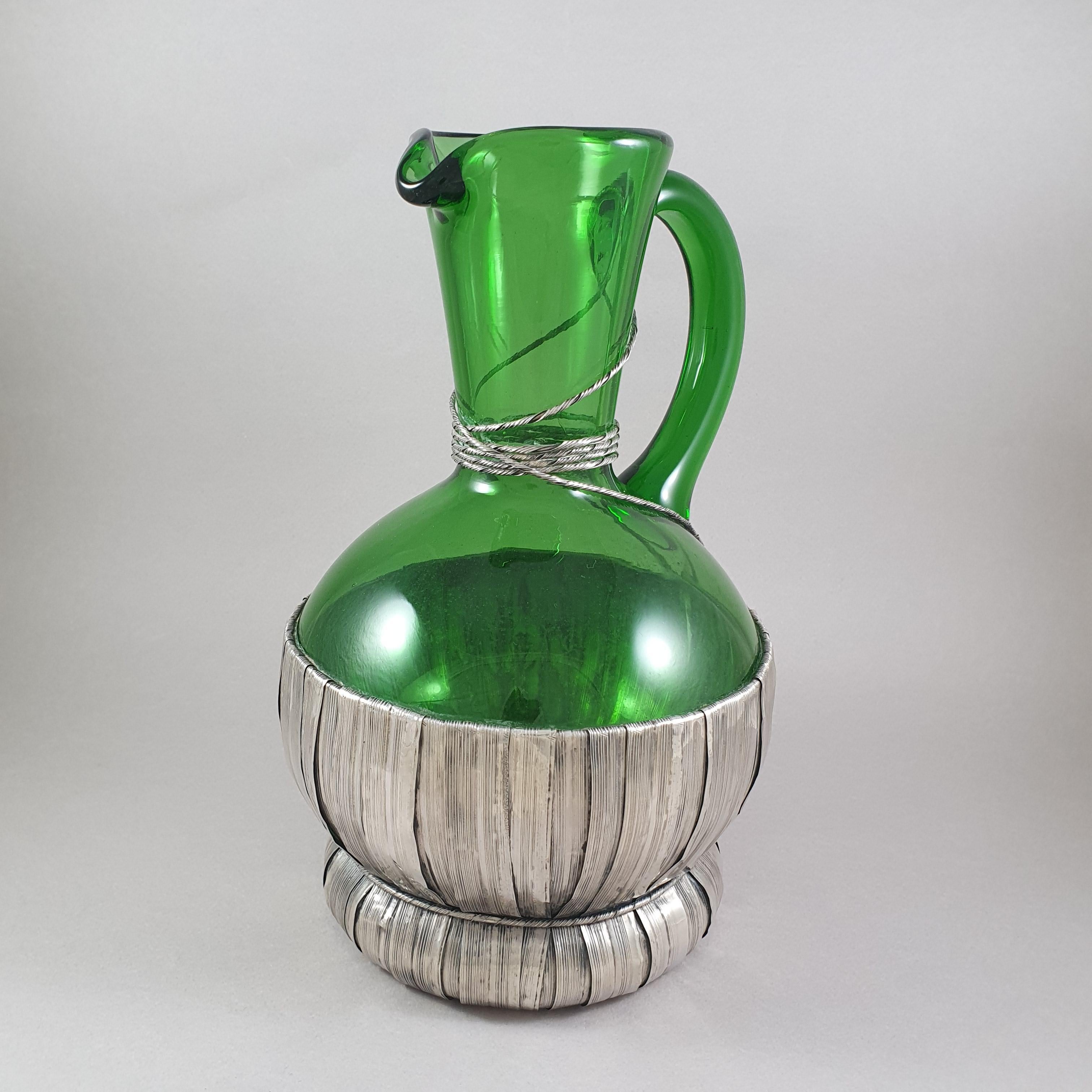 Beautiful pitcher in glass and solid silver 

The frame in imitation of basketry 

Italian work around 1970 

800 Silver hallmark 
Silversmith: Vavassori 

Measure: Height: 23 cm 

In good condition.