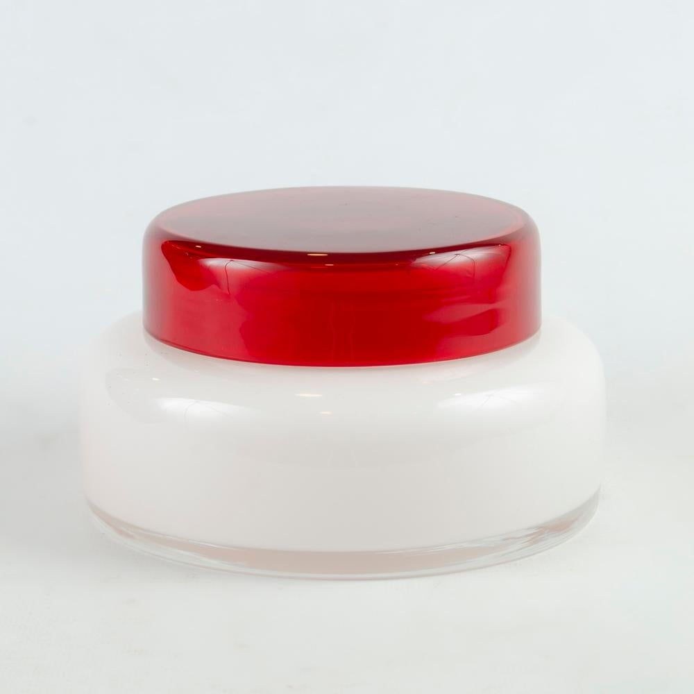 Italian glass candy jar from the 1970s

Beautiful Candy Box, Bombonera type, made of Opal glass. Handcrafted in Italy during the seventies, in red and white
Measures:
Height: 9 centimeters
Diameter: 14.5 centimeters