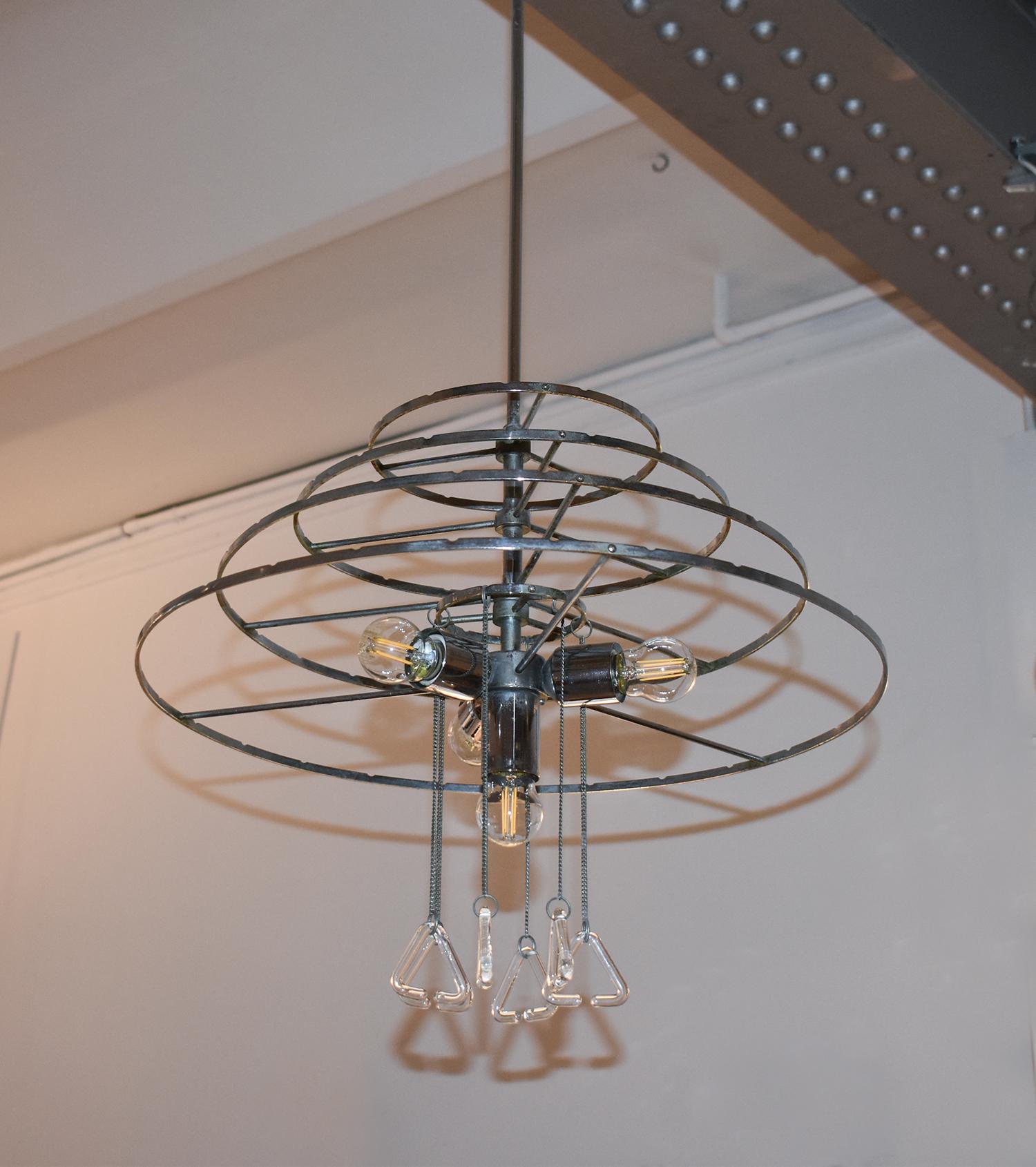 Italian chandelier from 1970's, in the manner of Angelo Mangiarotti works. Made of many  of transparent murano glass pieces  interlaced with triangular form and chrome structure with four lights.
The lamp has been rewired again.
