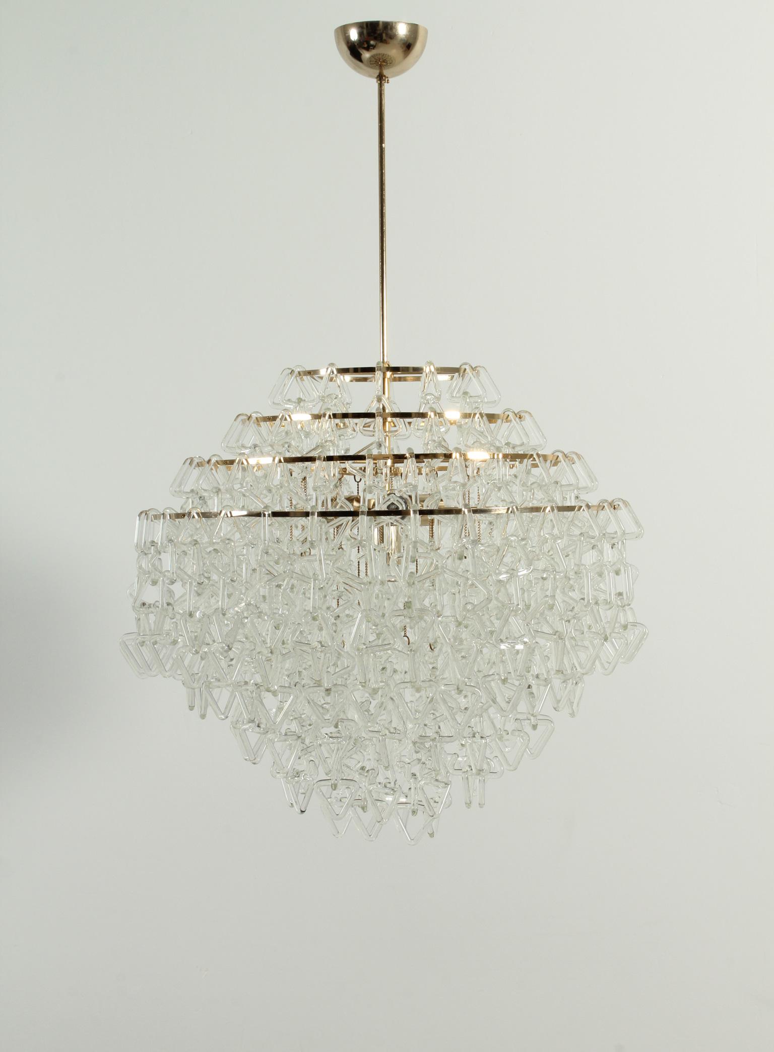 Exceptional Italian chandelier from 1970's, in the manner of Angelo Mangiarotti works. Made of hundreds of Murano glass pieces interlaced with triangular form and brass structure with four lights.