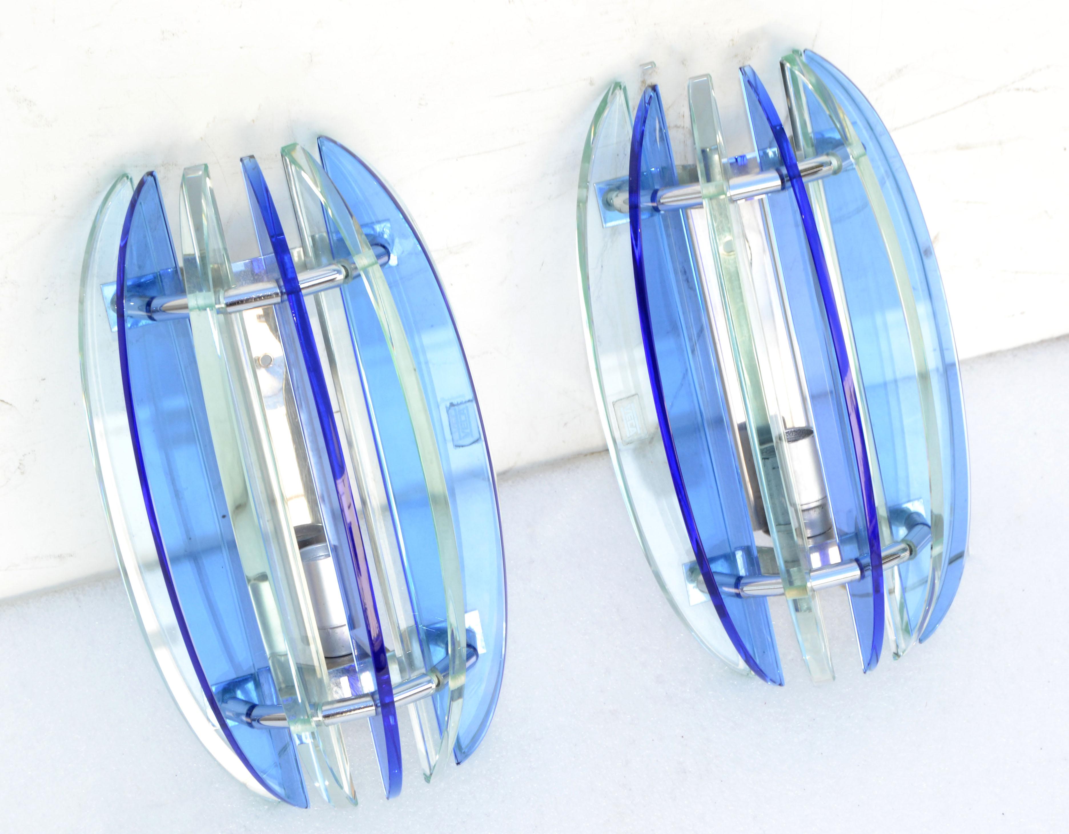 Superb pair of blue and clear glass blades Sconces by Veca.
We have 2 pair available, priced by pair.
US rewired and each Sconce takes one light, 60 watt max.
Back Plate measures: 6.25 x 1.5 x 0.25 inches height.
Projection of the Wall: 4.5