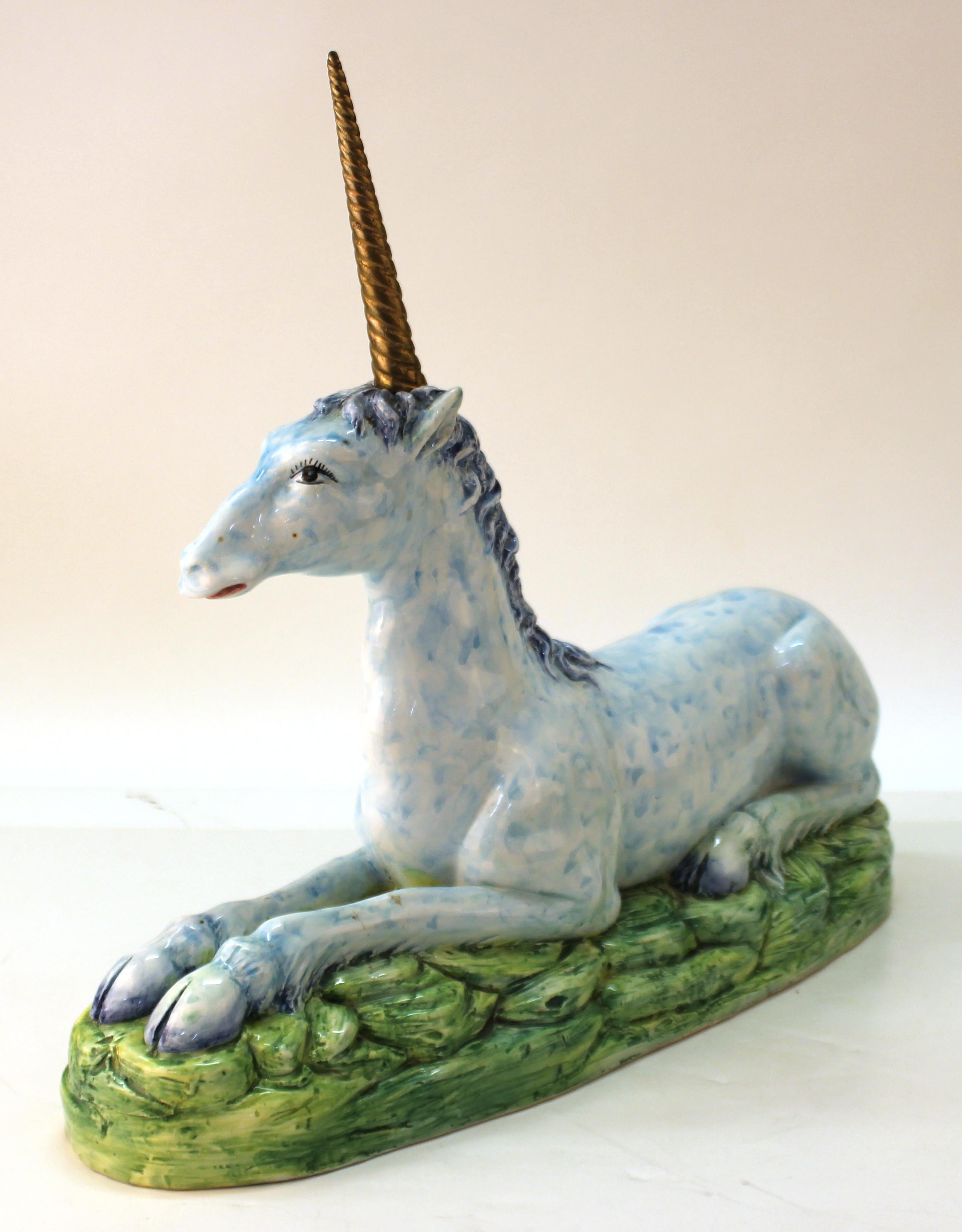 Italian modern glazed hand-painted ceramic sculpture of a blue unicorn with a removable brass Horn. The piece is marked 'Italy' underneath and shows minor repair work above the proper right eye. In great vintage condition with age-appropriate patina