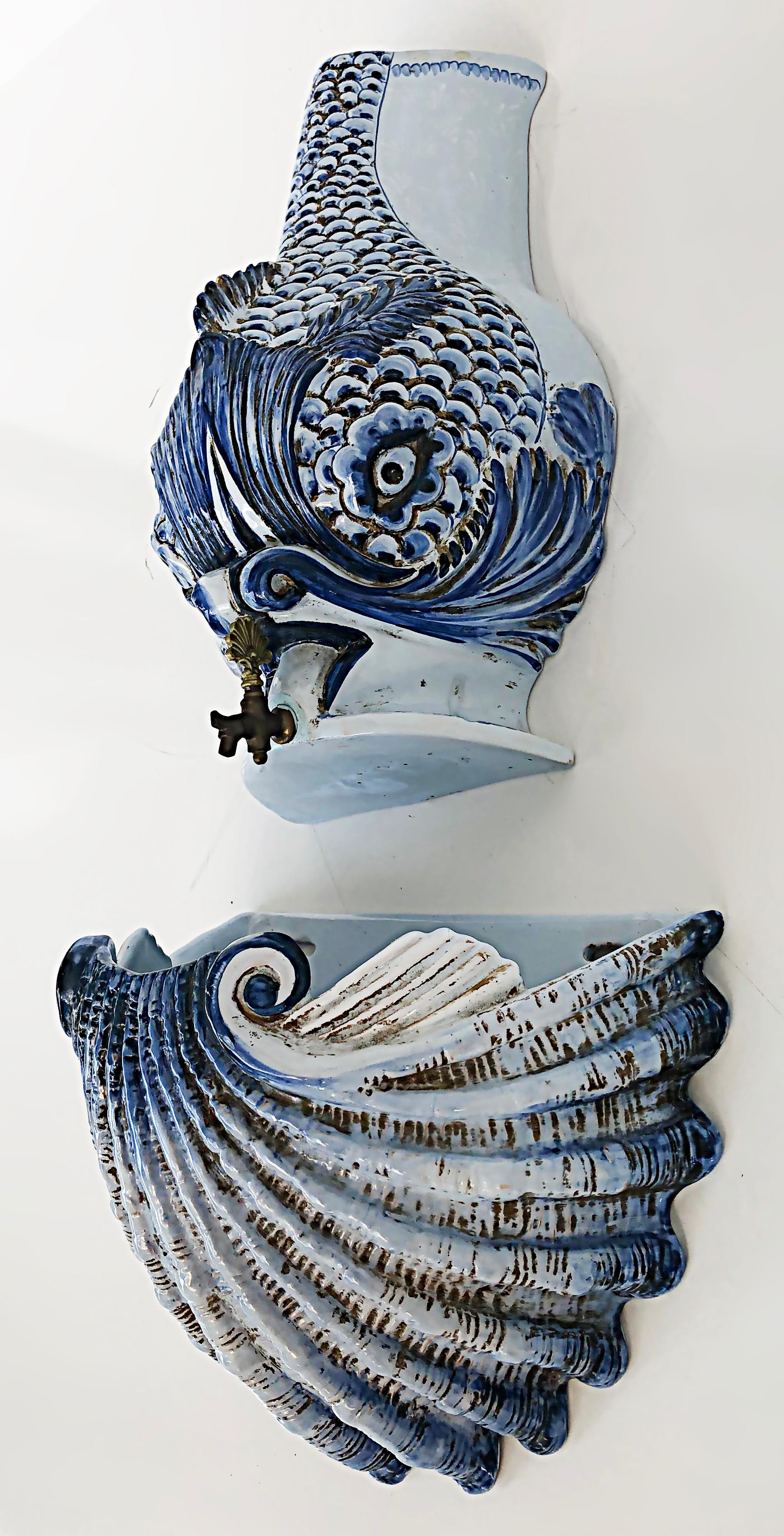 Italian glazed ceramic dolphin wall fountain lavabo with shell.

Offered for sale is an Italian garden ornament of a glazed ceramic dolphin wall fountain with a shell collector for the water. The dolphin design is after works by Pierre Joseph