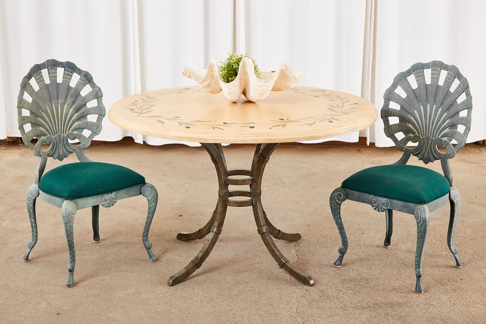 Country Italian style iron pedestal dining table or centre table featuring a thick glazed pottery ceramic top. The round top is decorated with a mosaic style olive branch design inlay around the border with a 1.5 inch thick ogee edge. Supported by a
