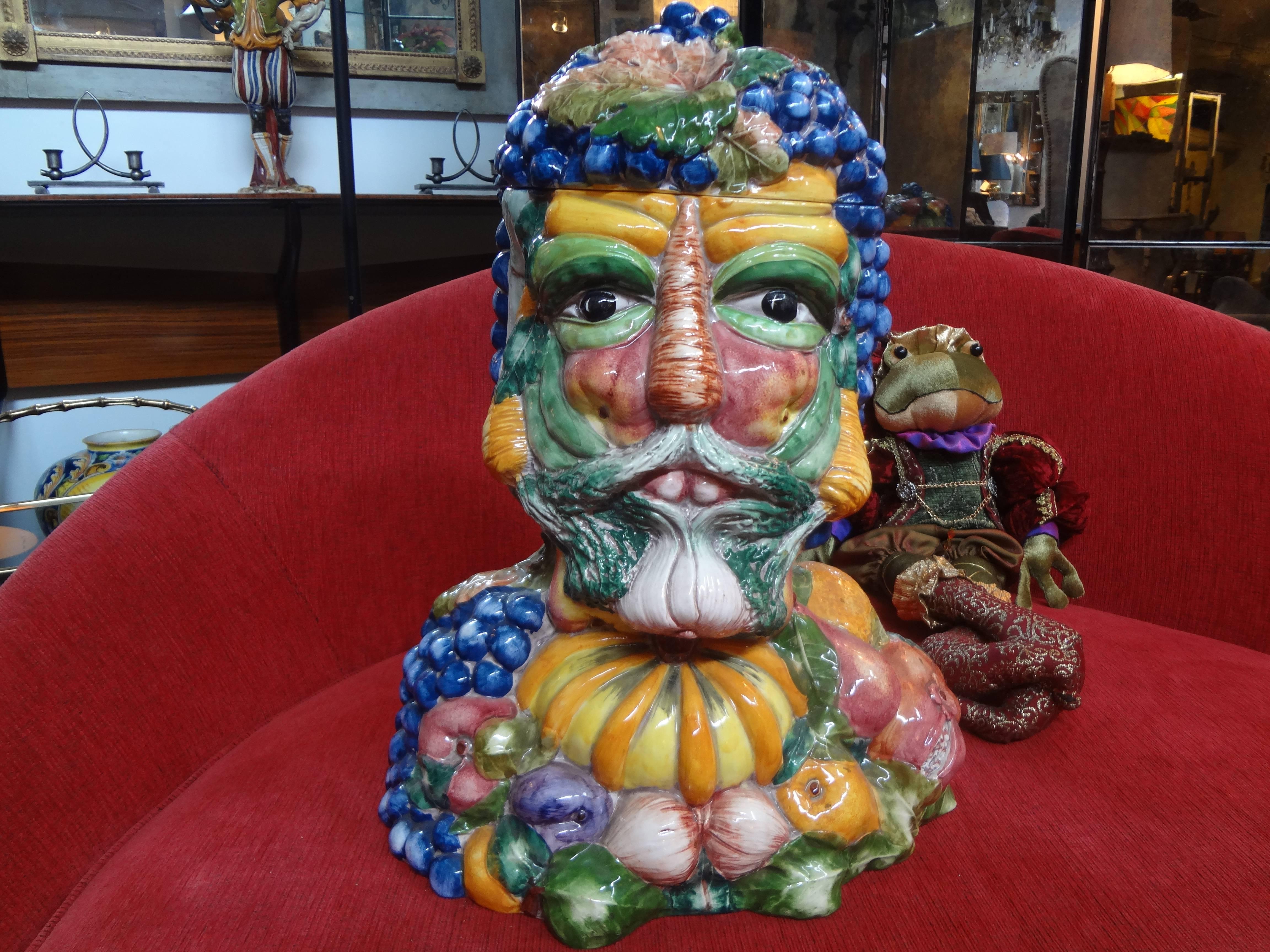 Italian glazed pottery lidded vessel or jar in the style of Giuseppe Arcimboldo, 16th century Italian painter. The colorful bust sculpture is adorned with vegetables and fruits and produced in the 1960s.