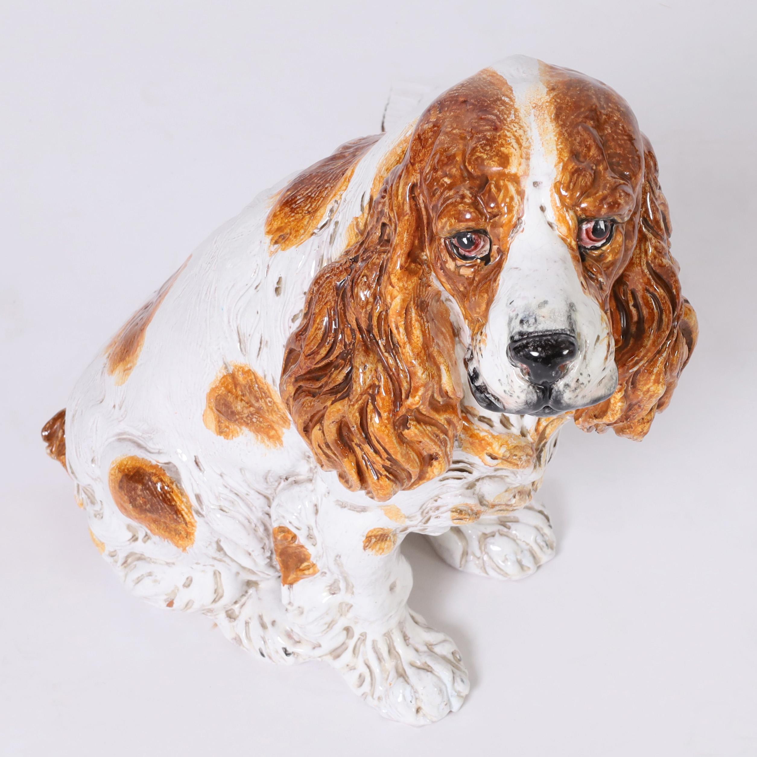 Charming Italian Cocker Spaniel sculpture crafted in terra cotta, hand decorated and glazed, complete with soulful expression.