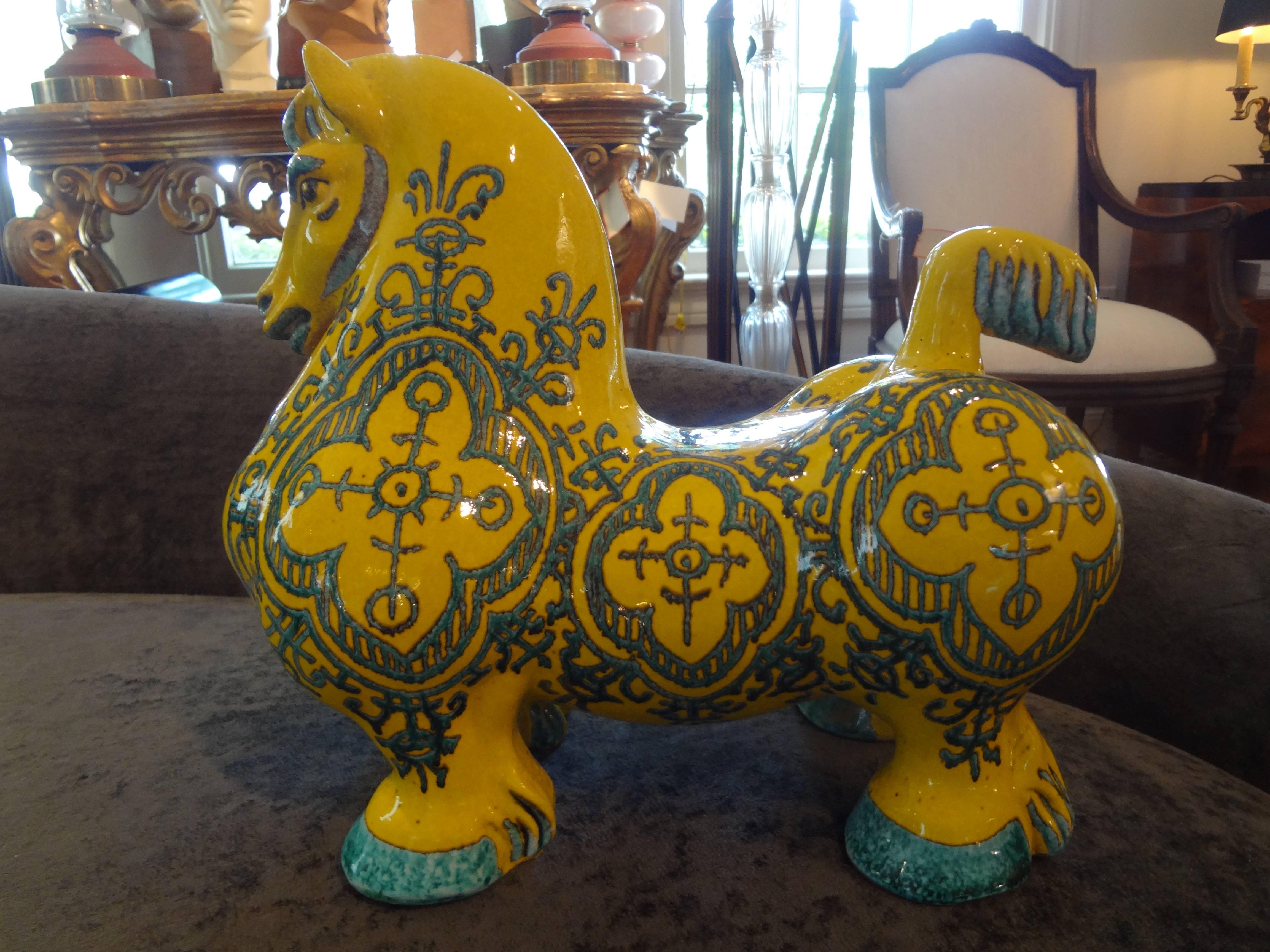 Beautiful Hollywood Regency style Italian glazed terracotta horse sculpture. This unusual Bitossi inspired horse is bright yellow color with turquoise accents. It dates to the 1960s and is marked Italy.