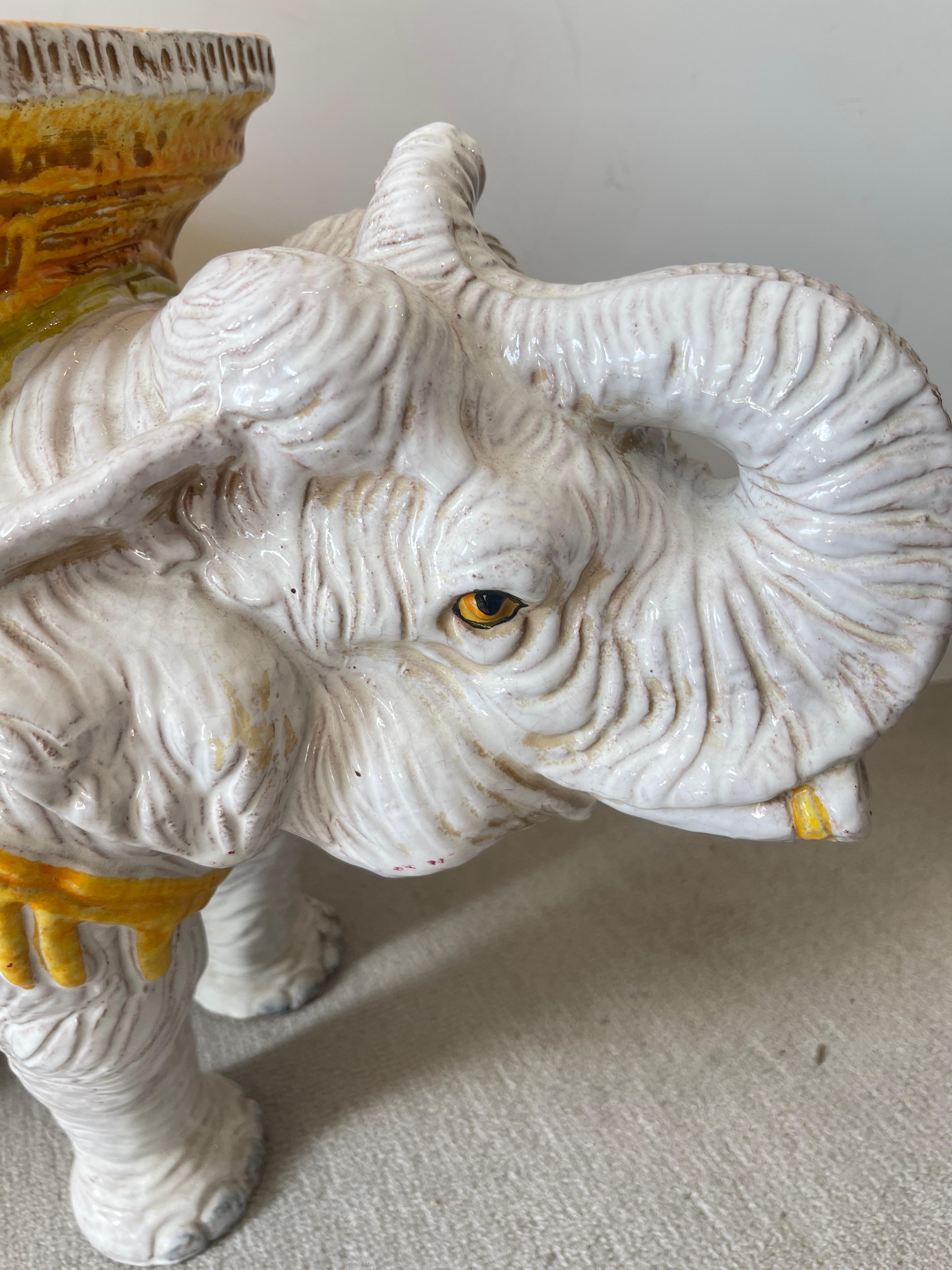 Just in, this charming is smaller in size, Italian Glazed Terracotta Elephant Garden Seat. 
The saddle and seat are a light Orange color with yellow Saffron.
The Elephant is an off-white color
Very good vintage condition, consistent with age and
