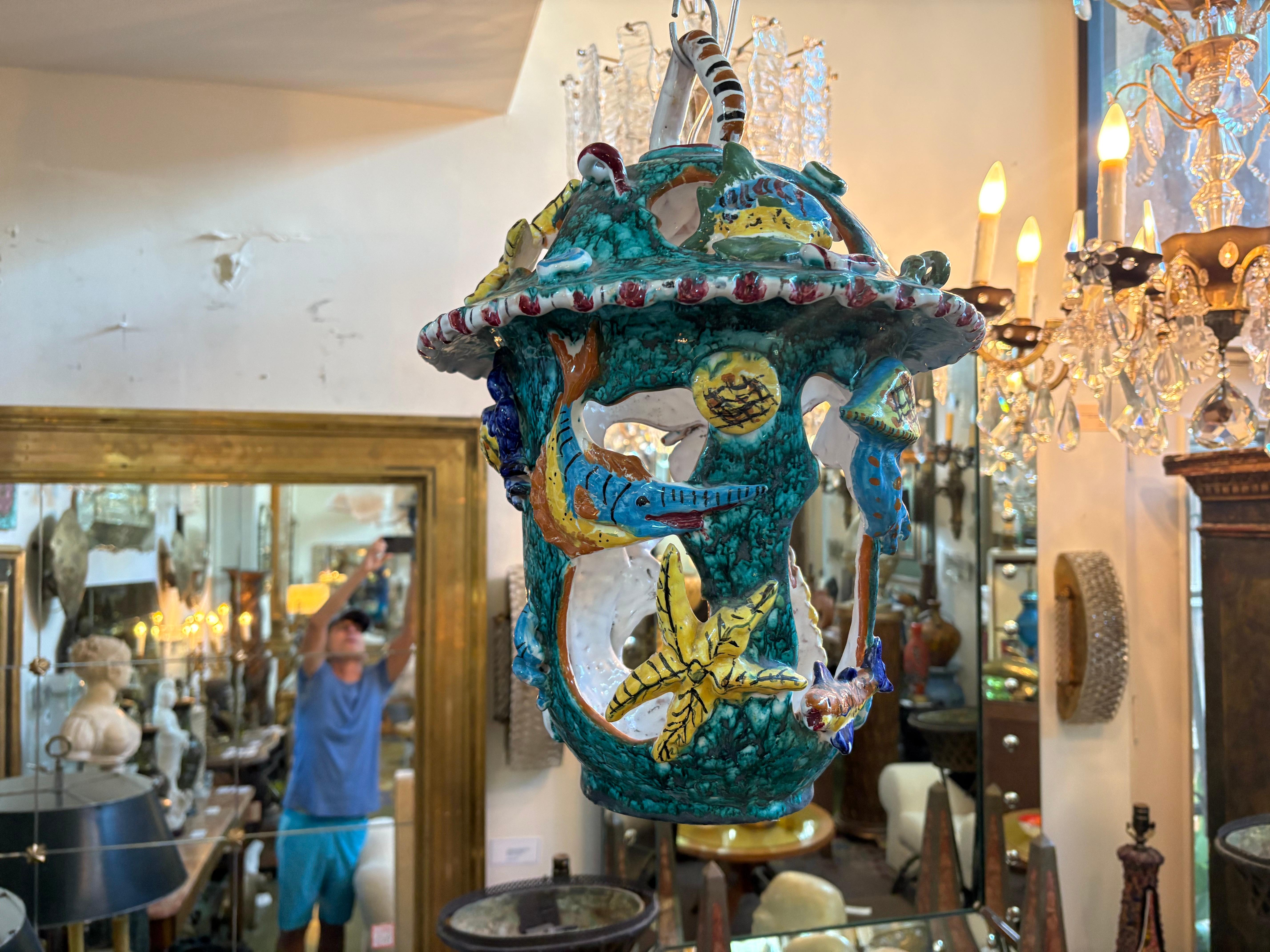 Italian Glazed Terracotta Lantern.
Offered is a lovely Italian glazed terracotta lantern from the Amalfi Coast of Italy. This beautifully detailed lantern displays a variety of sealife including starfish, octopus, crabs, seahorses and sharks in