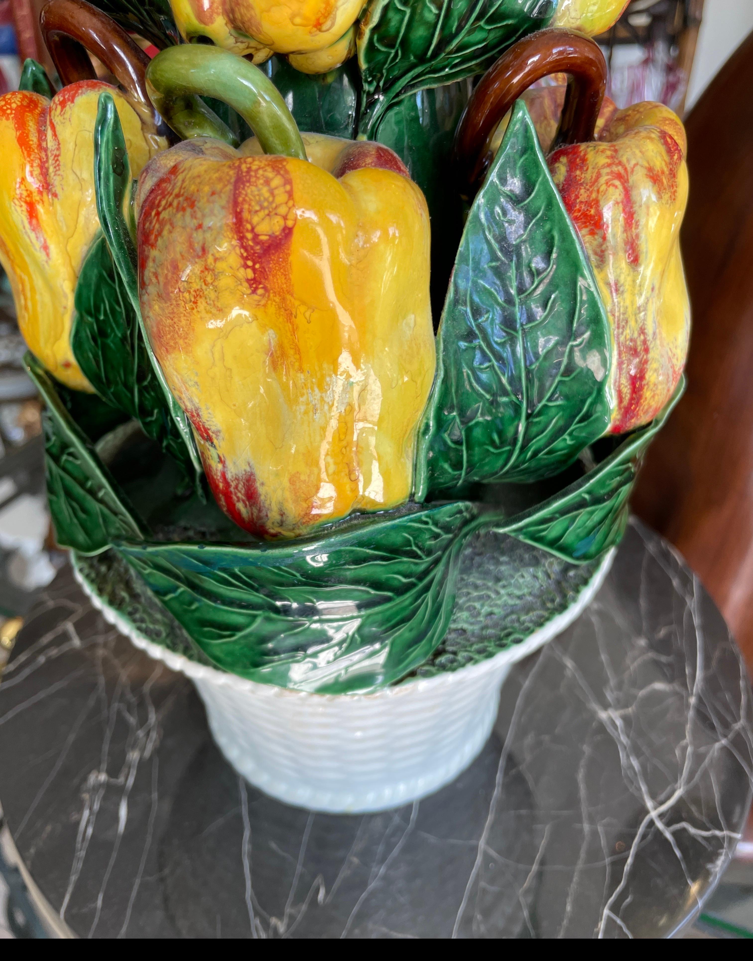 Lovely yellow and red pepper centerpiece basket. Authentic looking peppers wrapped in green leaves. A great pop of color.