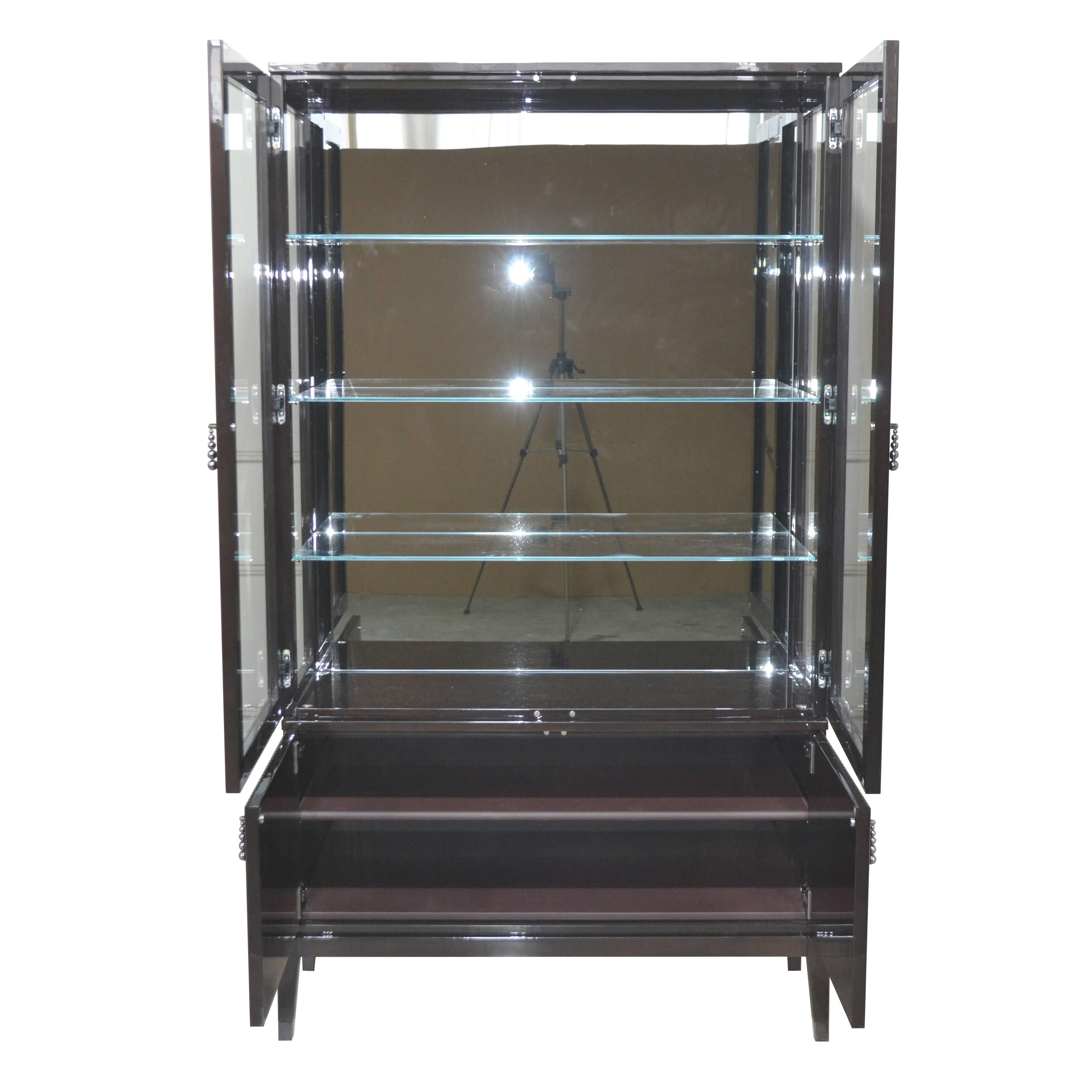 A Contemporary style curio cabinet by Cavio Casa Company. Glass front doors and side panels. Features lit interior cabinet with mirrored back and four glass adjustable shelves. Made in Verona, Italy.