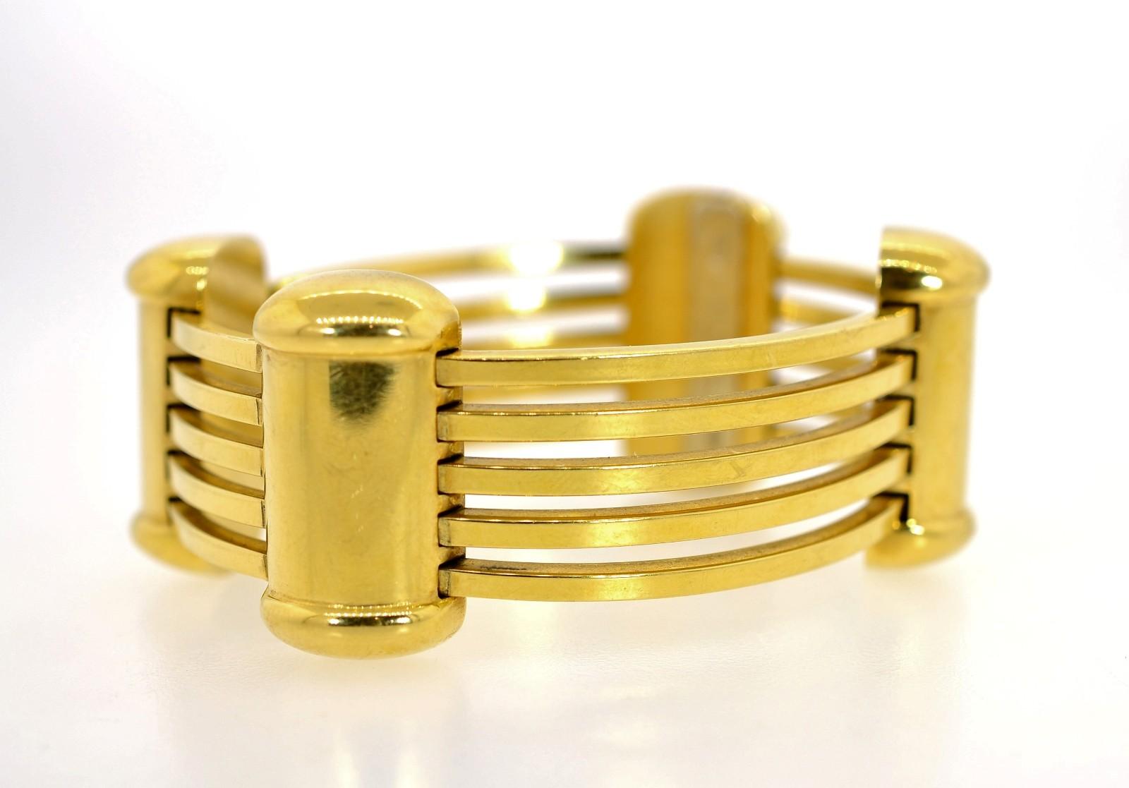 Beautifully crafted in 18KT yellow gold, this Italian made bracelet is quite impressive.  Long articulated tubes are connected by Retro-like dome sections.  Its  1 1/8
