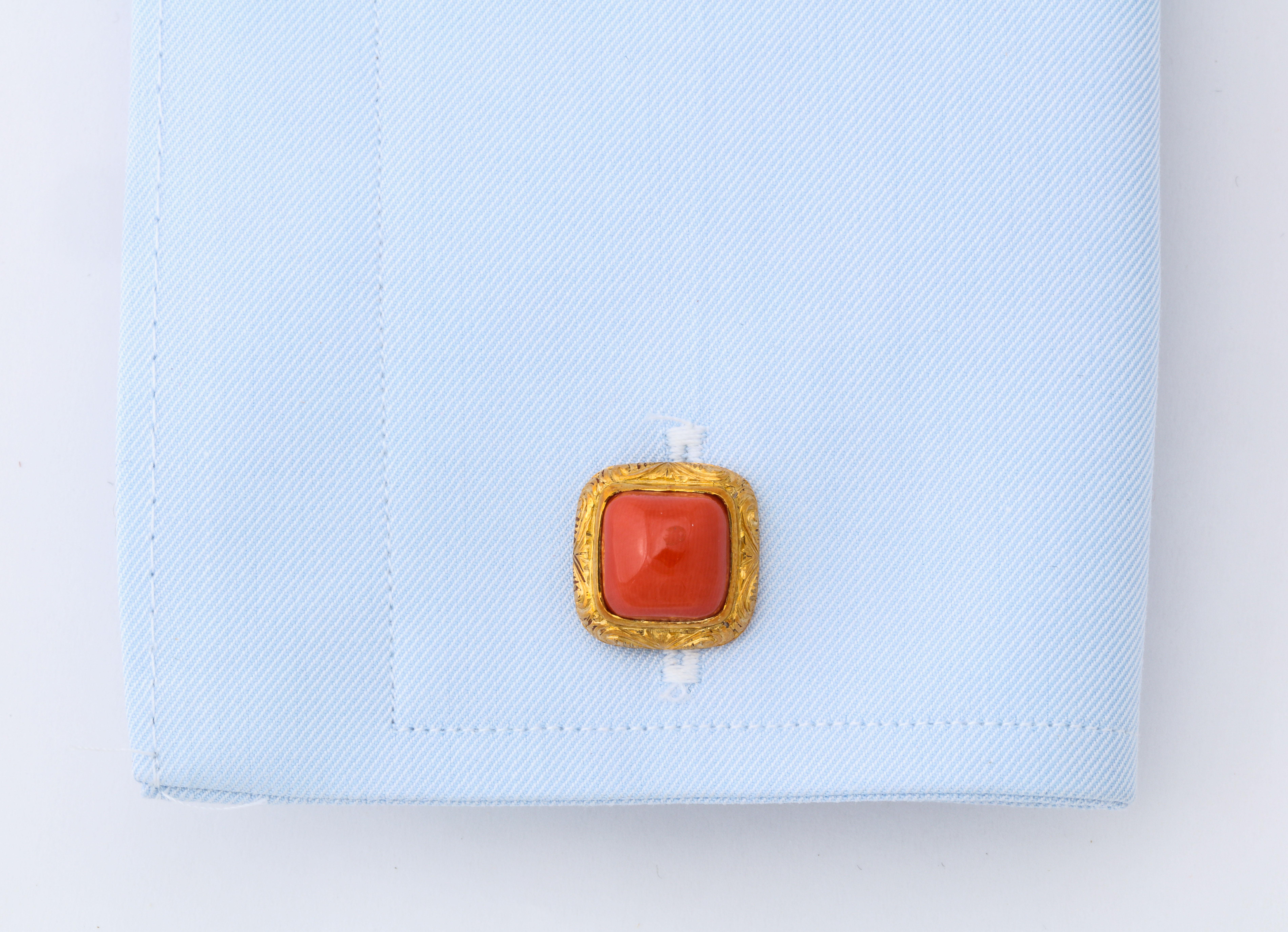 Very fine hand engraved gold cufflinks featuring four perfectly matched pieces of Sardinian coral.  Double sided cufflinks are a sign of true luxury and the exceptional hand engraving makes all the difference.  
Made in Italy.