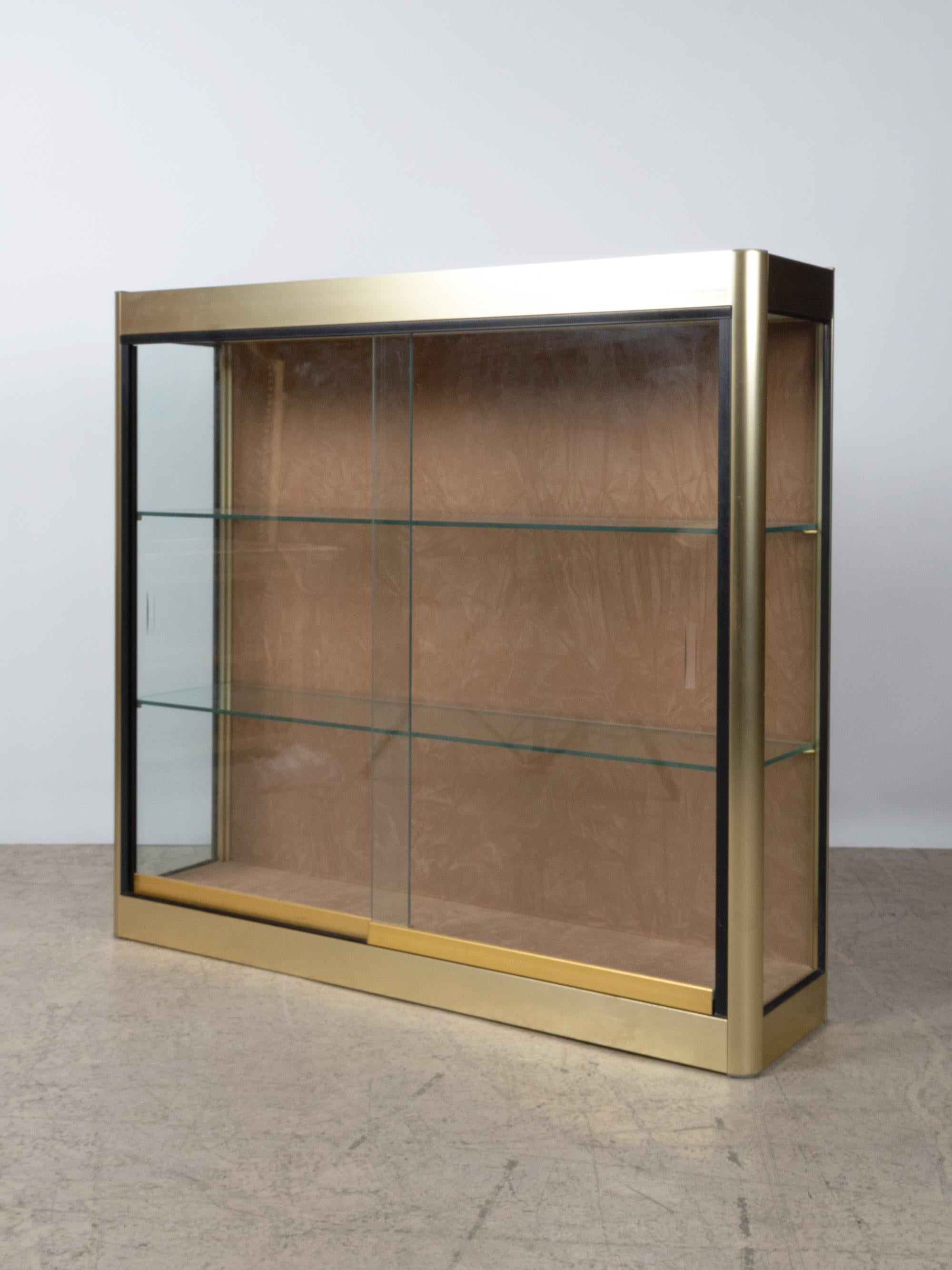 Italian gold-plated aluminium vitrine with two tempered glass shelves, and sliding glass doors.
Excellent vintage condition commensurate of age.
