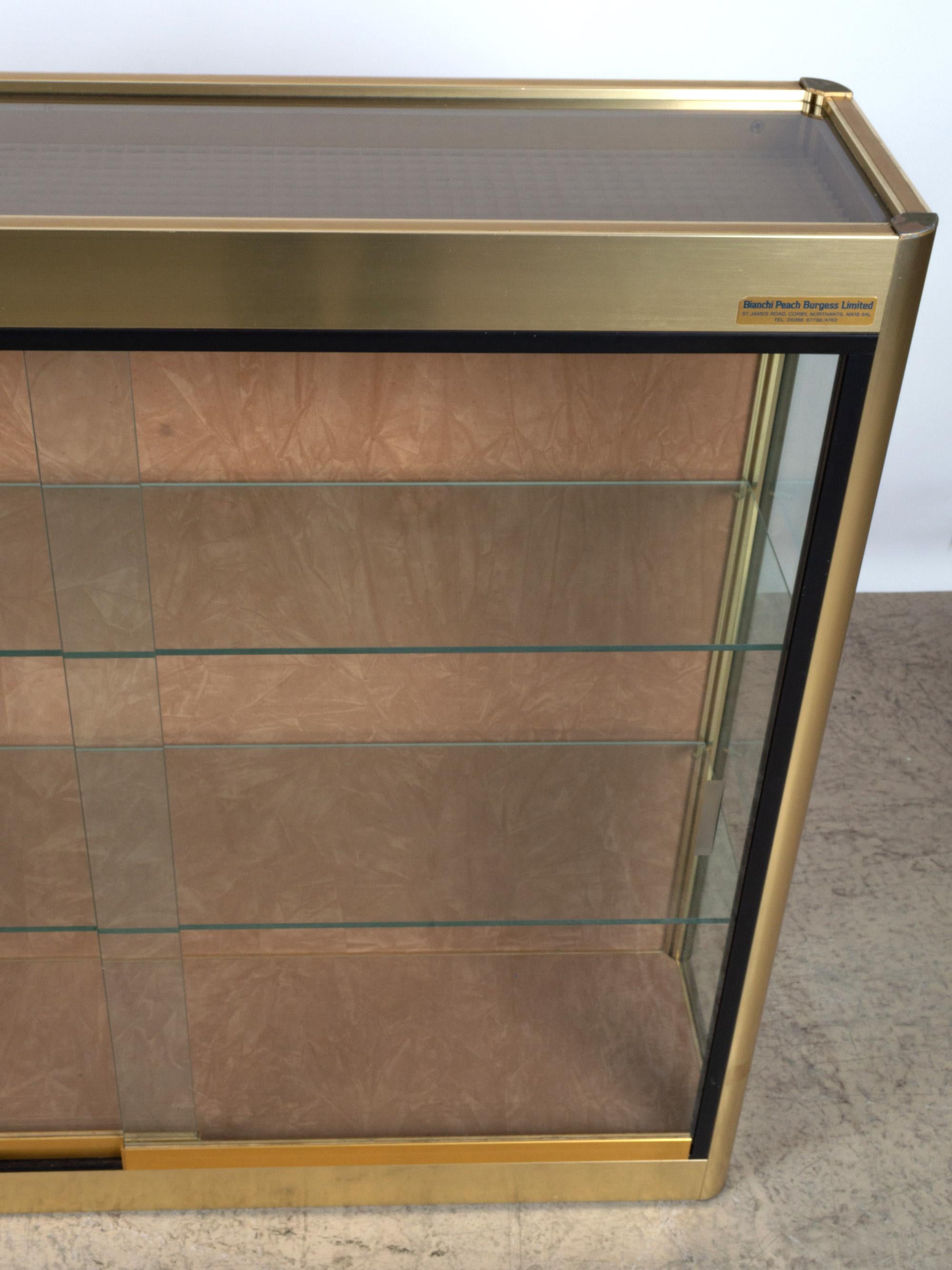 gold display cabinet with glass doors