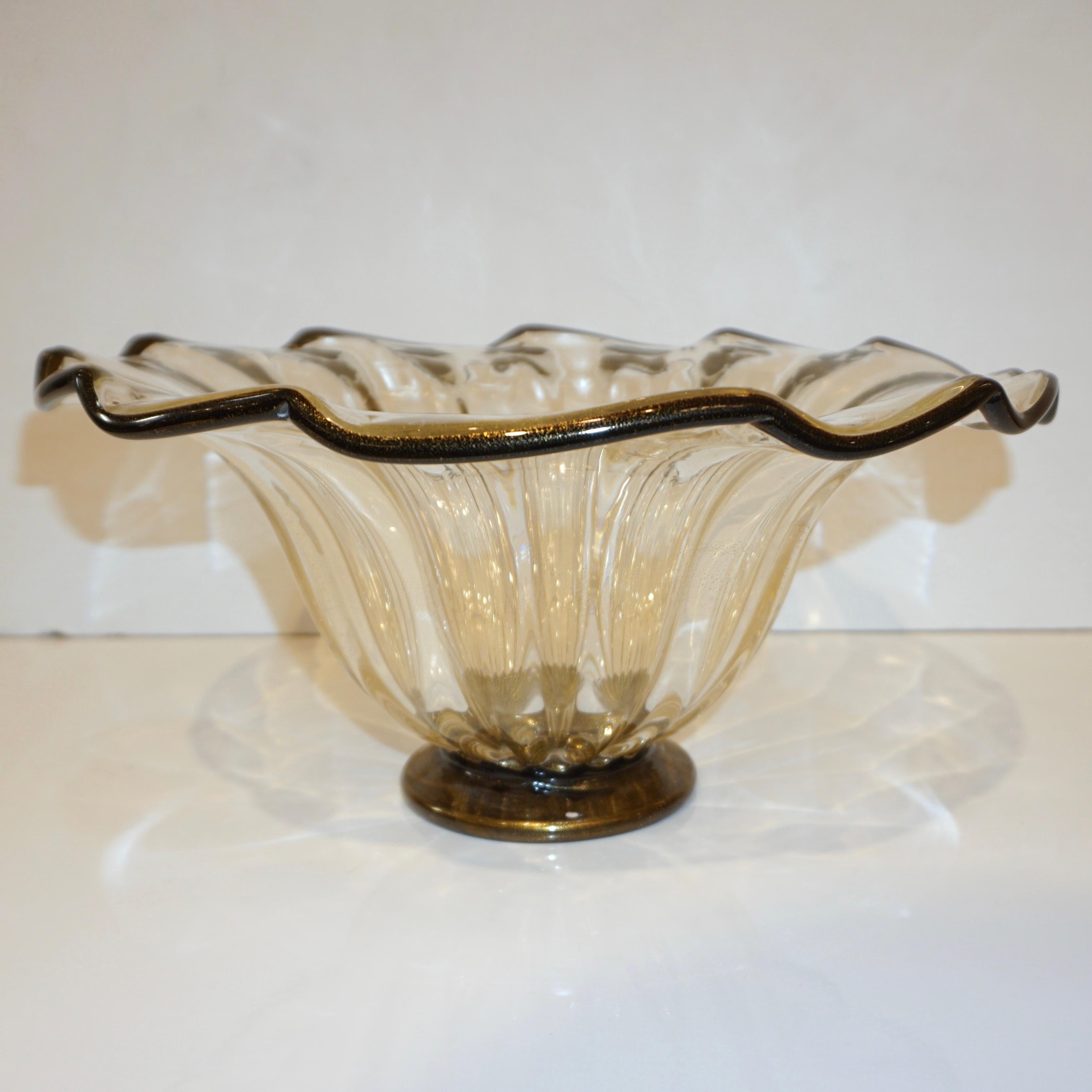 A Studio Art Glass modern centerpiece in blown Murano glass signed Alberto Donà Murano. The organic body in crystal Murano Glass is extensively worked with pure 24kt gold and expertly decorated with a black rim that enhances the open waved shape