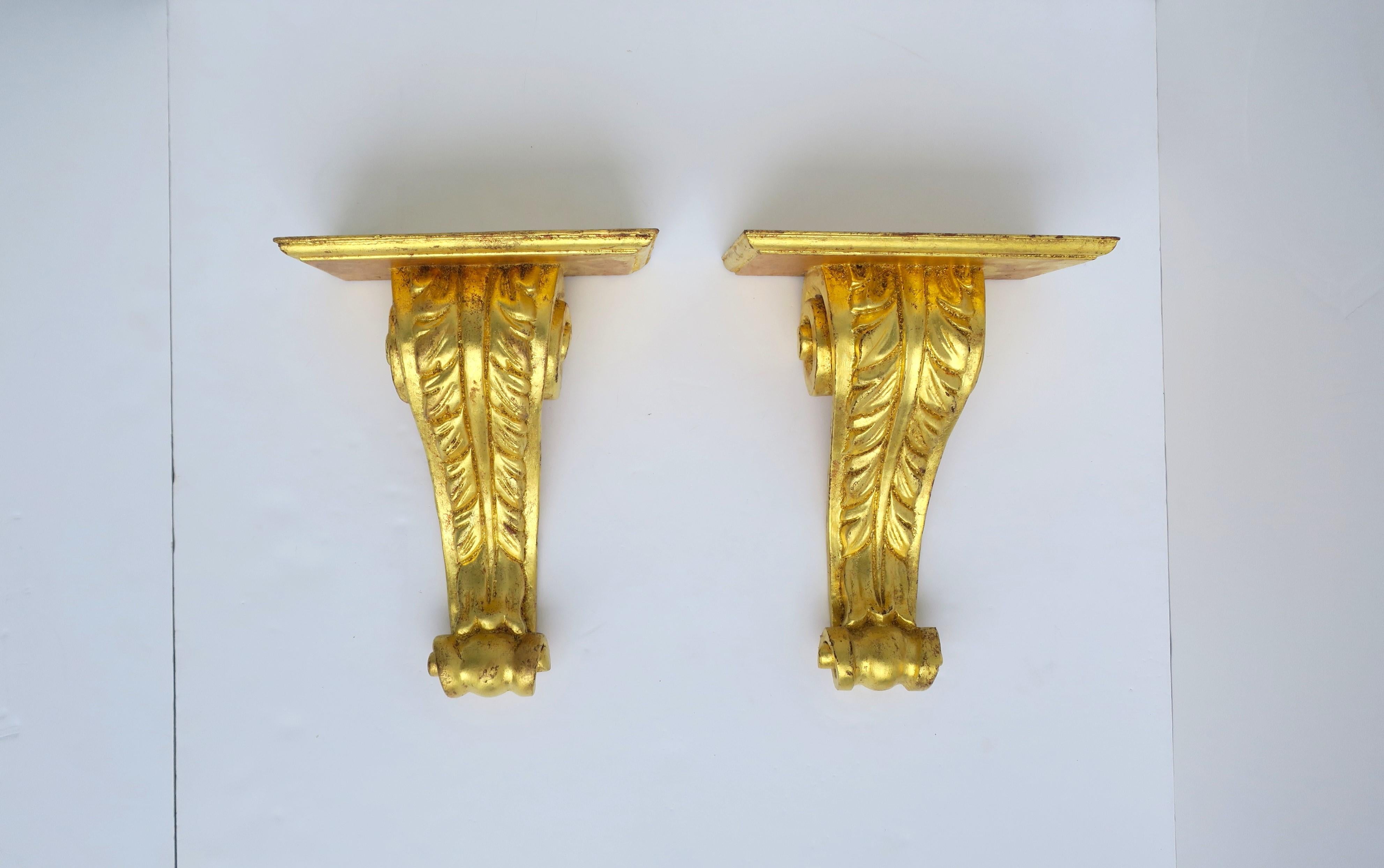 A beautiful pair of Italian gold gilt giltwood gold-leaf wall shelves, circa mid-20th century, Italy. Pair have rectangular shelf with acanthus leaf design and scrolled base. Marked 'Made in Italy' on the back of both as shown in last two images.