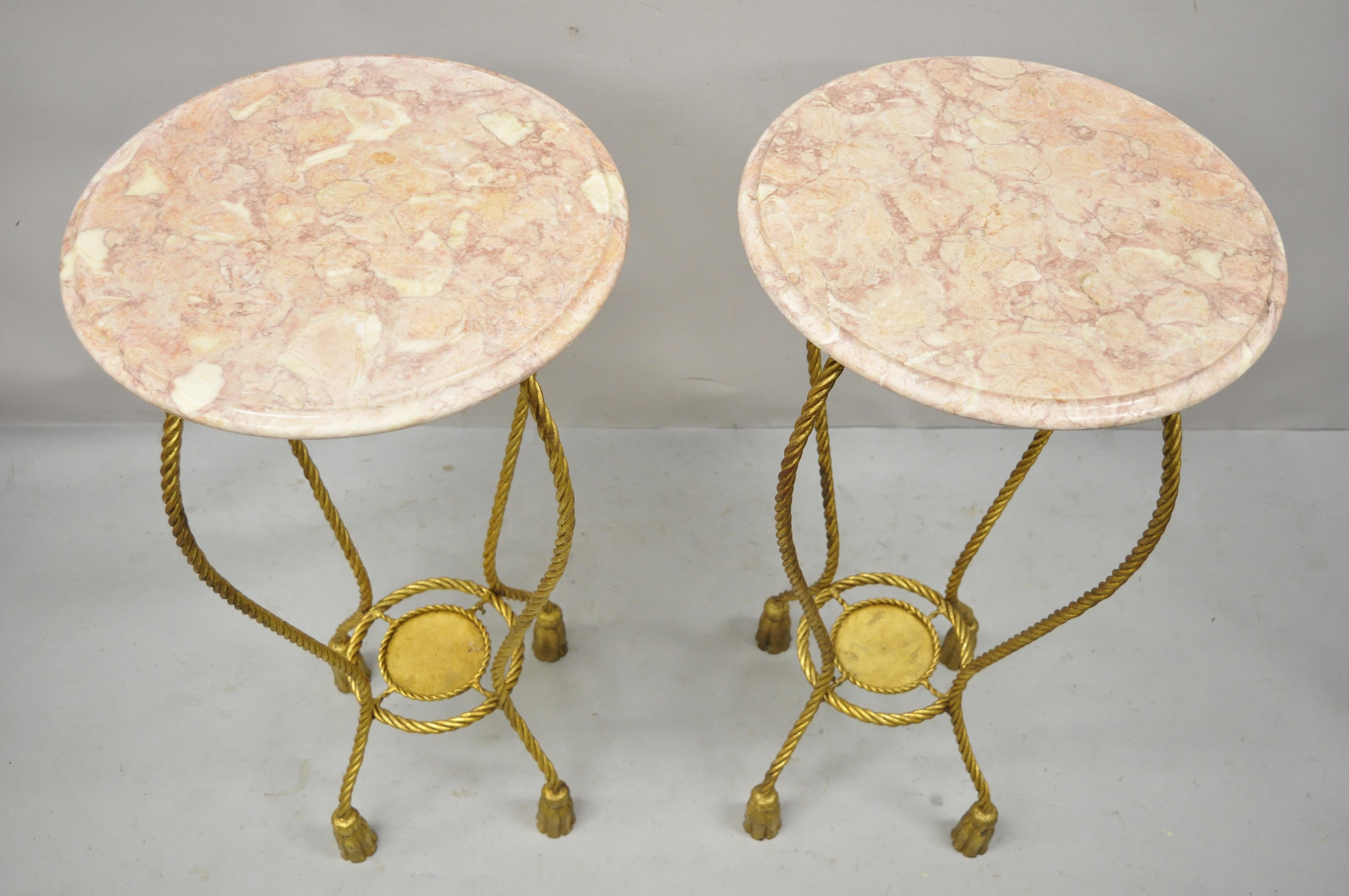Italian gold gilt iron rope tassel marble top tall pedestal plant stand - a Pair. Item features pink round marble tops, gold gilt iron rope and tassel tall bases, original Italian tags, very nice vintage pair, quality Italian craftsmanship. Circa