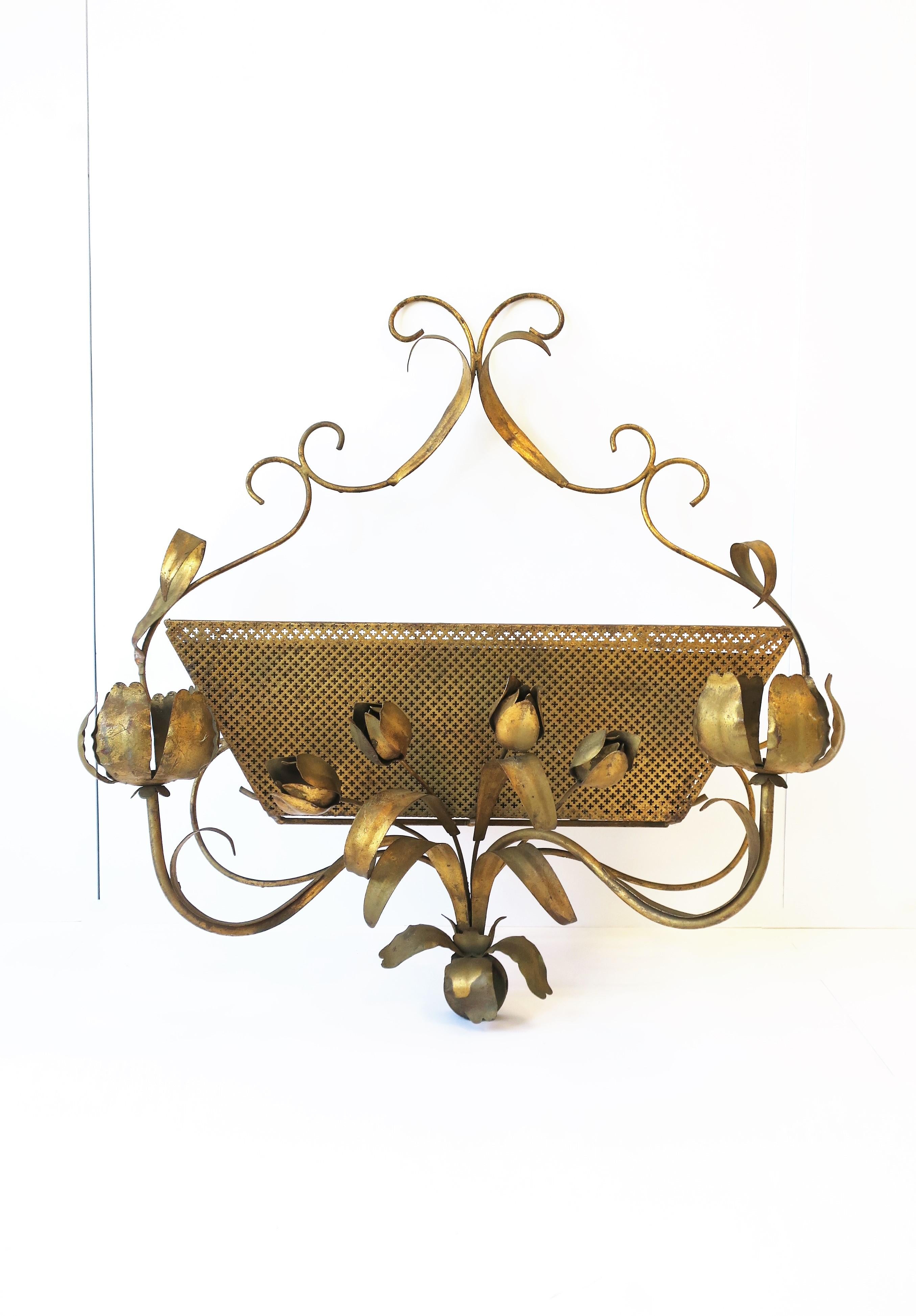 A gold gilt tole metal wall mount planter cachepot jardinière, circa mid to late-20th century, Italy. A beautiful piece embraced by gold gilt tole leaves and flowers (peonies and tulips.) Piece has rectangular insert pot/basket to hold flowers and