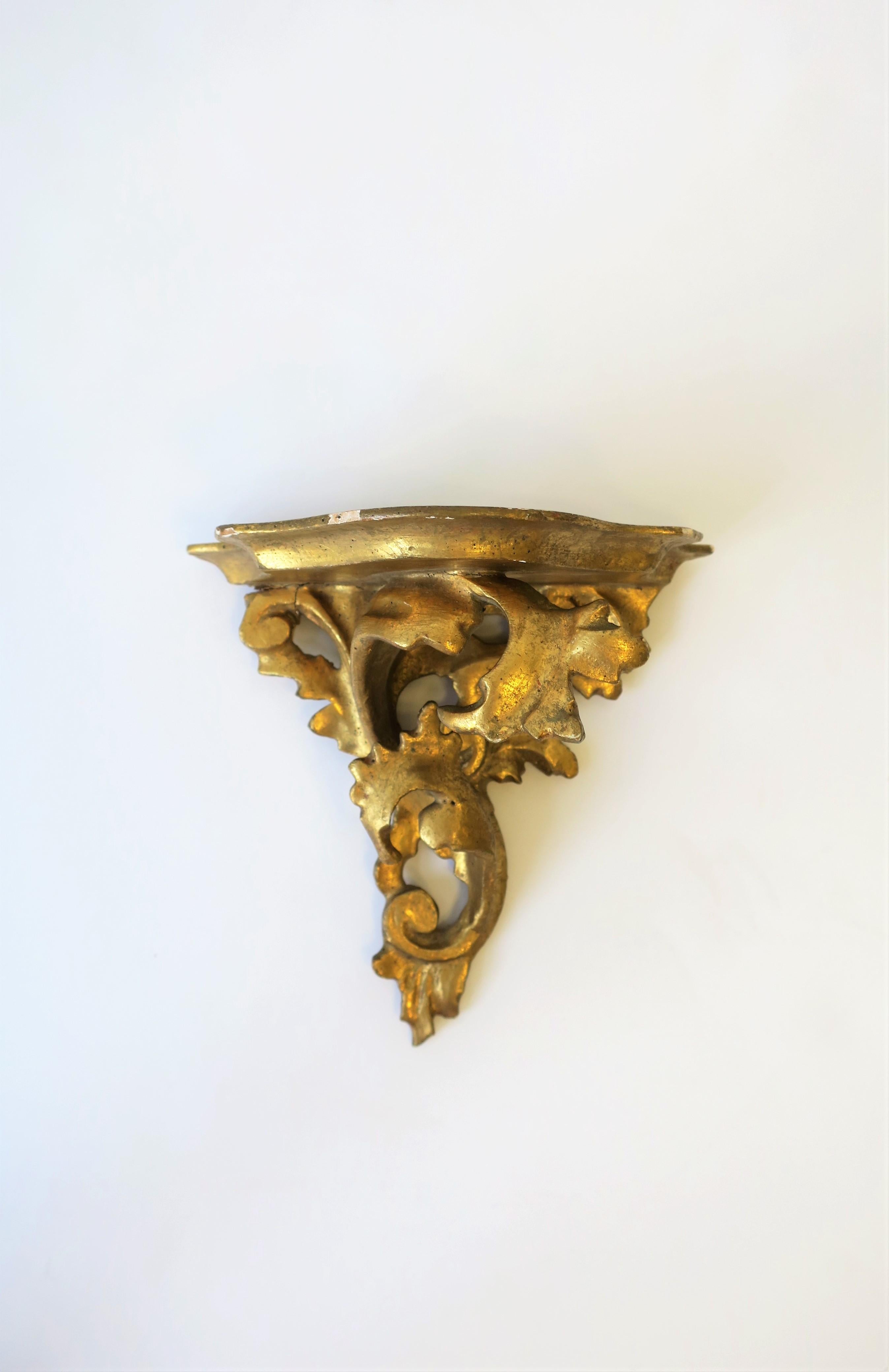 A beautiful, small, Italian gold gilt wall shelf bracket with acanthus leaf design, circa early 20th century, Italy. Piece is hand carved and finished with a heavy gold gilt over plaster and wood. Marked 'Made in Italy' on back as show in images #5