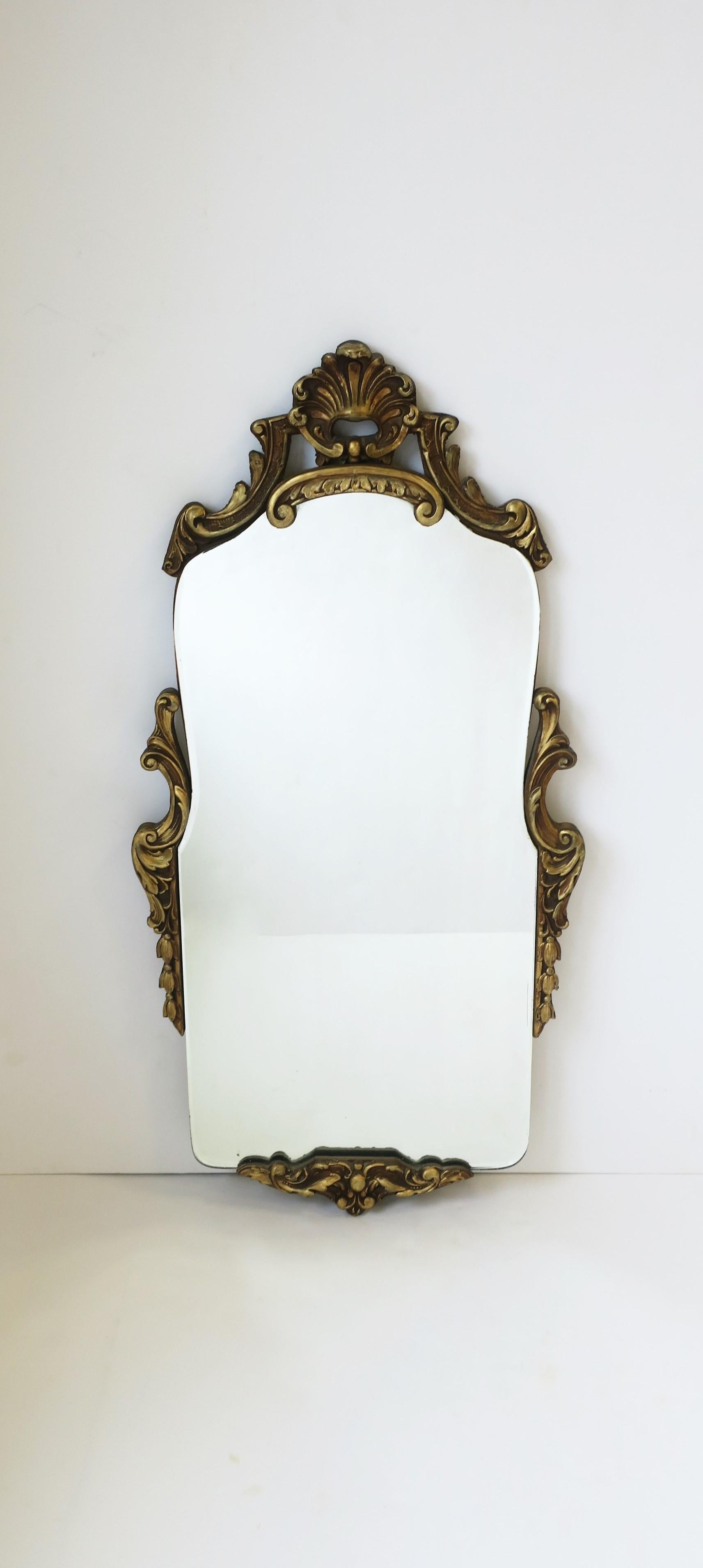 A great slender Italian gold giltwood wall mirror, circa mid-20th century, Italy. A great piece for a vanity bathroom, hallway foyer entryway, etc., where you may need a smaller/slender mirror. Dimensions: 1.38