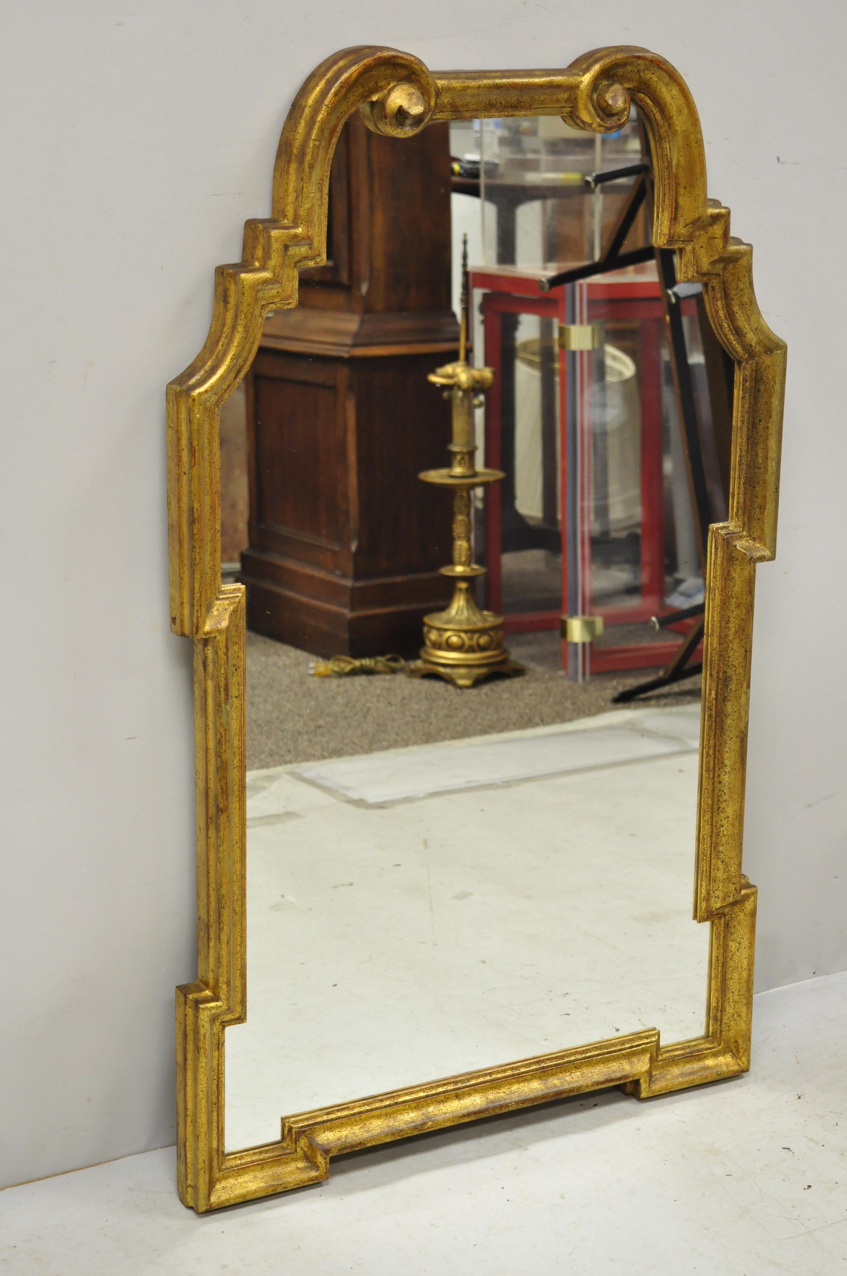 Italian gold giltwood Hollywood Regency scroll wall console mirror by Kent Coffey. Item features the original Italian label, distressed gold finish, carved wood frame, great style and form, circa mid-20th century. Measurements: 40.5