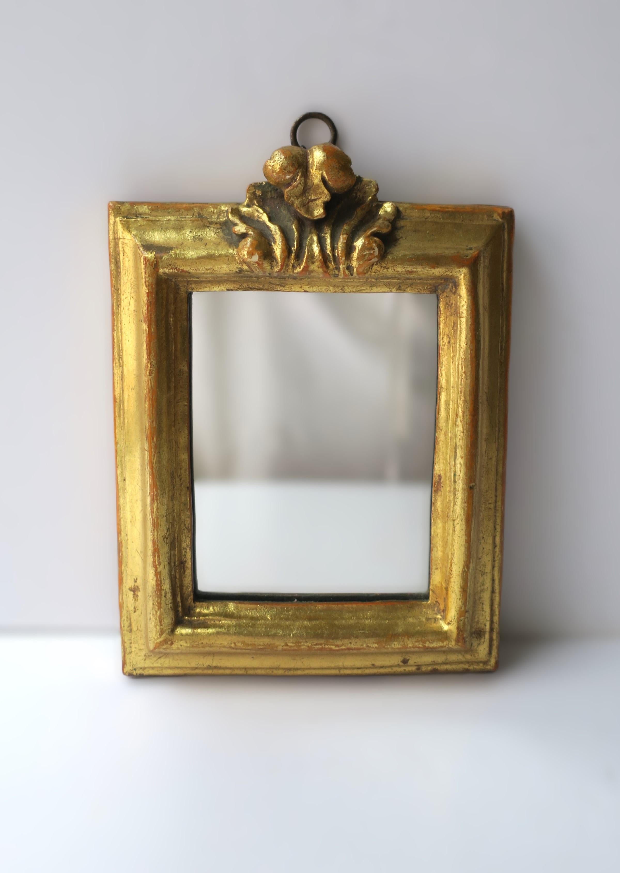 A small well-made Italian gold giltwood wall accent mirror, with acanthus leaf design, by Borghese, as marked, circa early to mid-20th century, Italy. Mirror is prepared for hanging with brass loop at top, as shown. Mirror frames face perfectly.