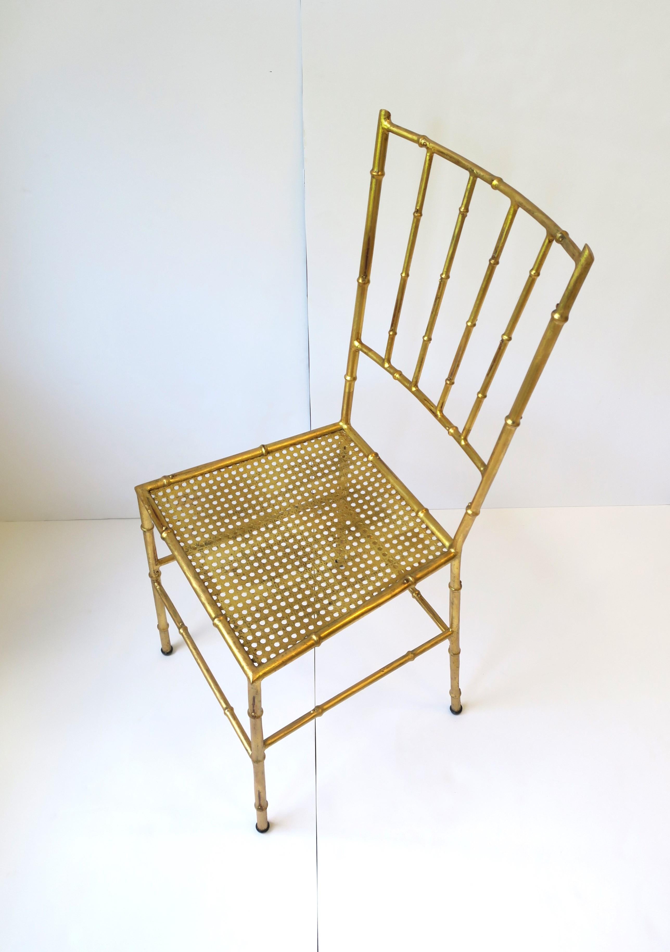 An Italian gold gilt metal cane and bamboo-esque desk, dining or side chair, circa mid-20th century, Italy. Chair has a metal 'bamboo' frame with a metal 'cane' seat finished with gold gilt and a pillow seat cushion (optional.) A great side, hall,