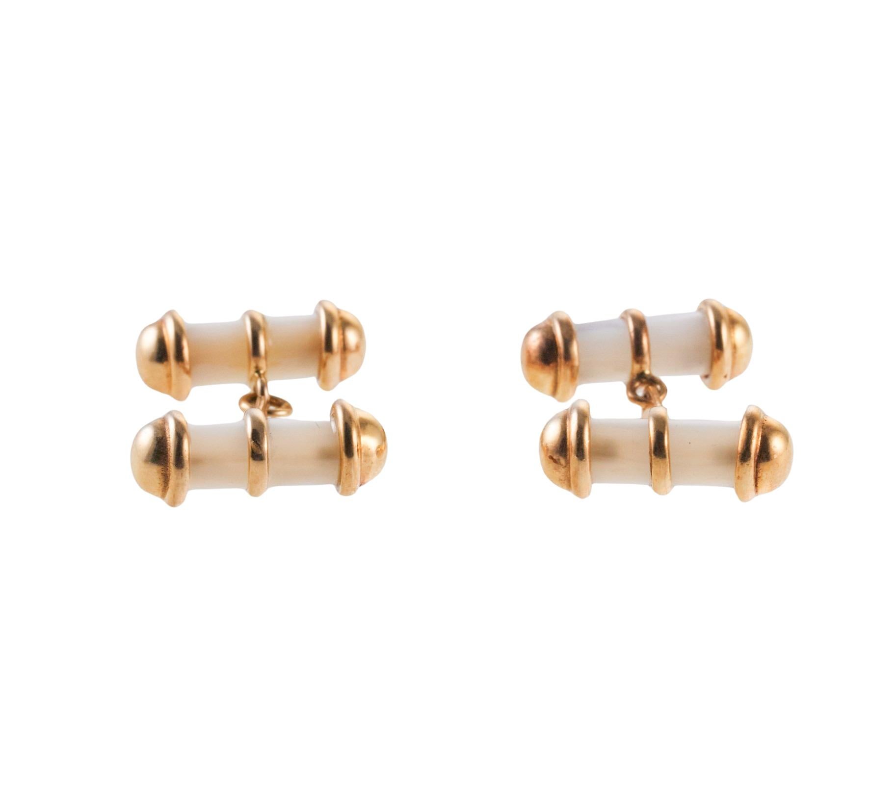 Pair of 18k gold Italian made cufflinks, with mother of pearl center. Each bar top measures 20mm x 7mm. Marked with Italian mark and 750. Weight of the pair - 14.4 grams. 
