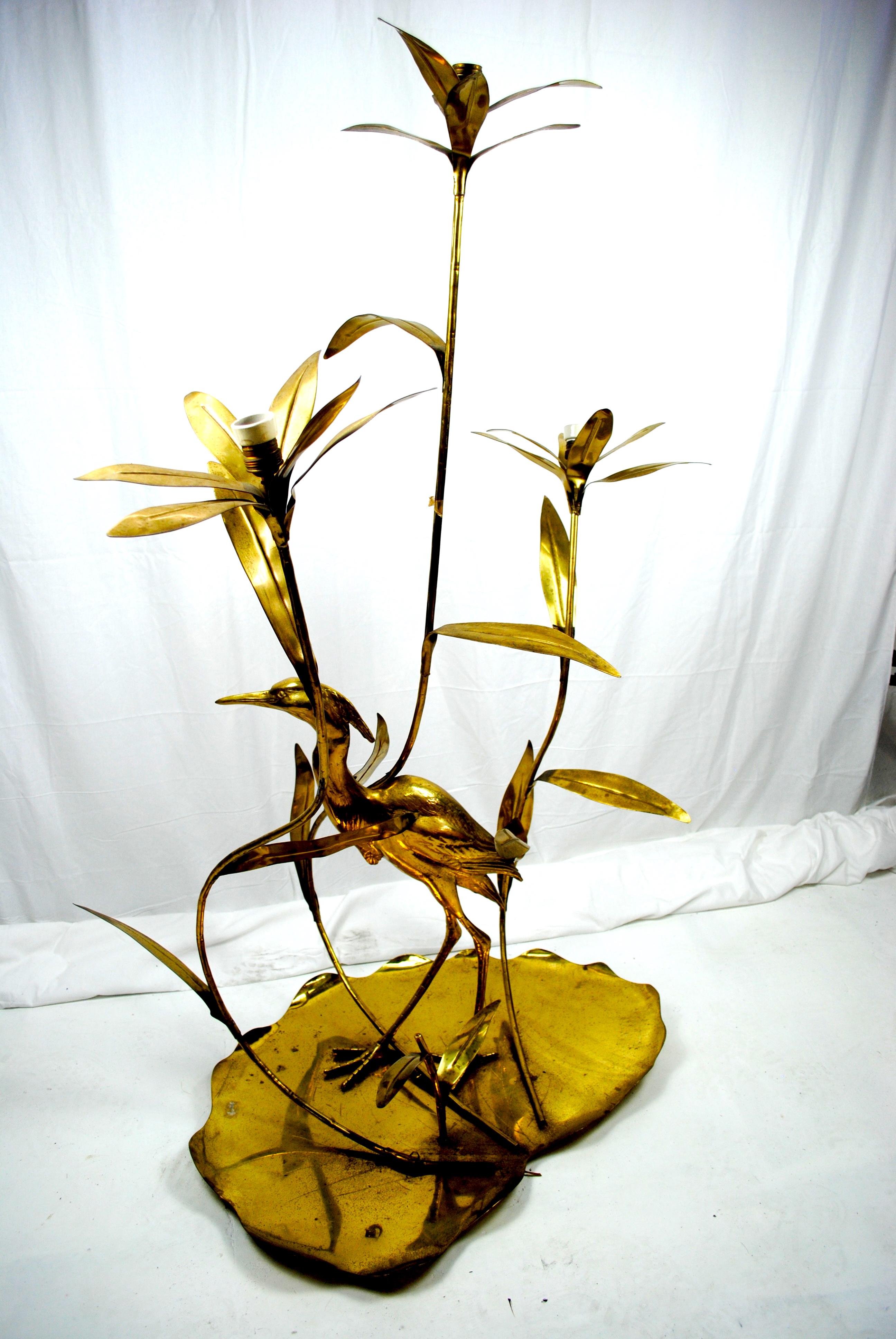 Floor lamp entirely made out of brass designed by Alfredo Freda, an important Italian designer in 1960s. Three lights. This lamp represent a crane /heron between the stalks of the lotus or lily flowers. The mark of the production company is