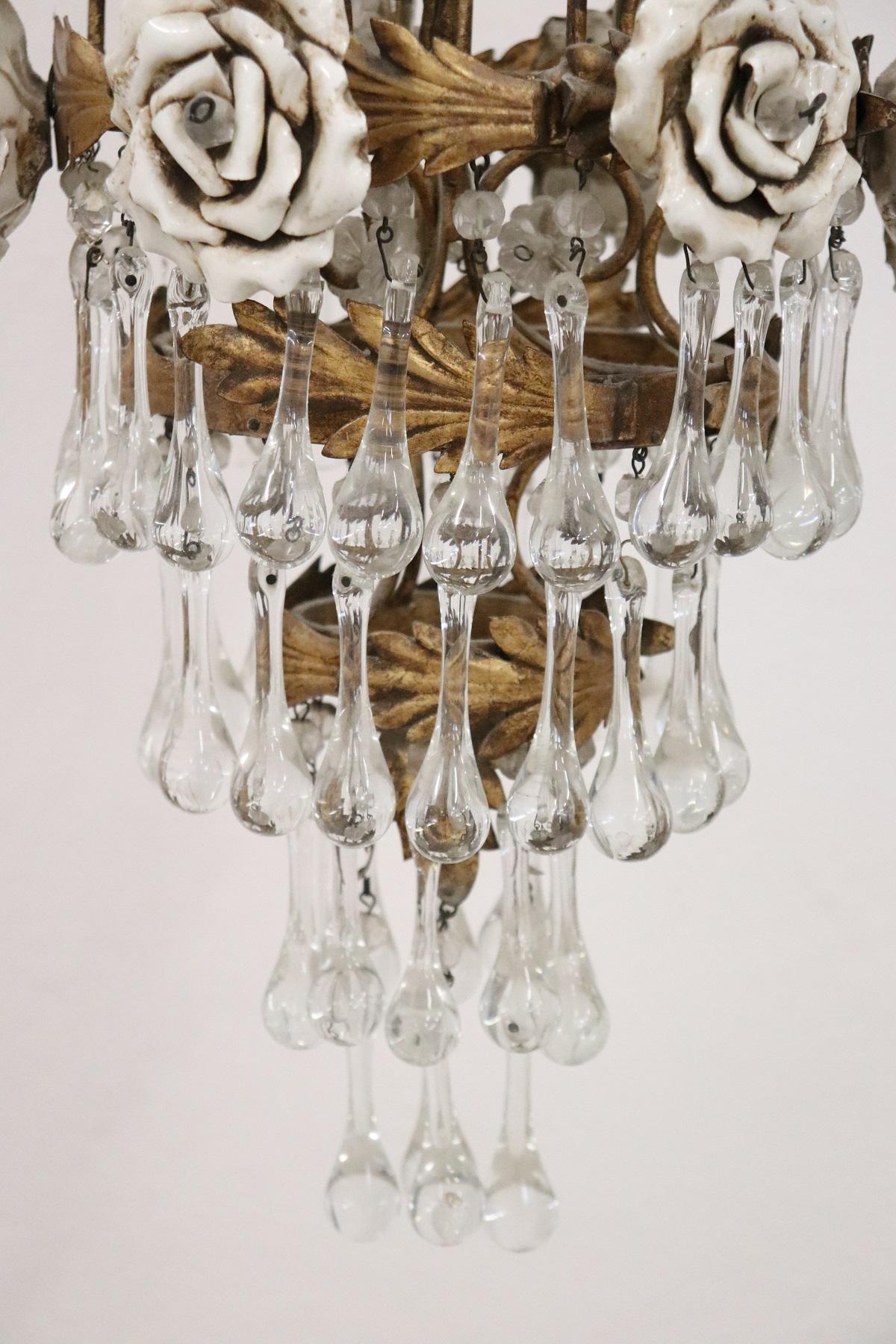 Beautiful and refined Italian, circa 1920s chandelier three lights. In golden bronze and completely covered drops of crystal Swarovski. The crystal exudes the typical brightness; the drops are finely worked giving an elegant light. Particular and