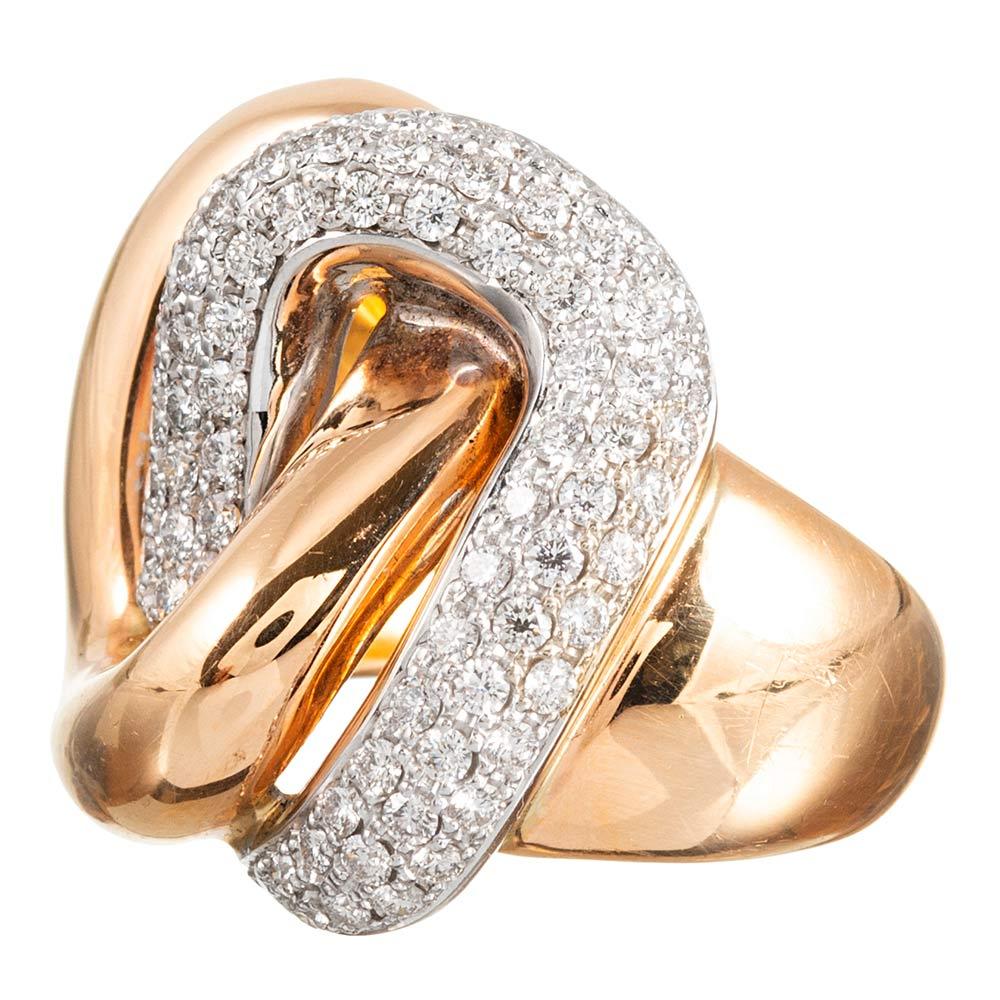 Sophisticated and bold with a hint of mid-century flair, this 18 karat yellow gold ring is designed as a pair of interlocked links that could be interpreted as a modern “toi et moi” ring. The diamond-studded link is made of 18 karat white gold and