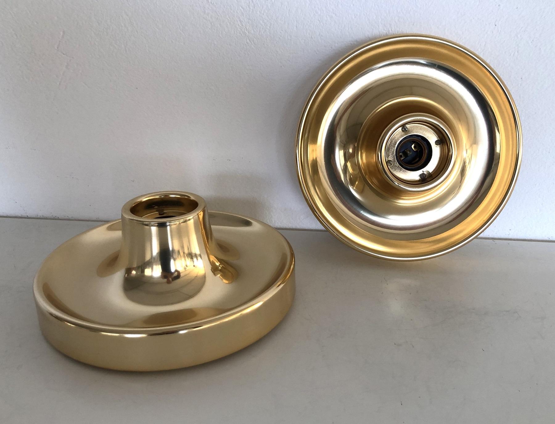 A Pair of golden, very shiny painted flush mount lights. Can be used also to be mount at the wall.
Made in Italy in the style of Achille Castiglioni in the 1960s.
The lights are simply to mount to ceiling ( or wall ) and use a standard Edison bulb