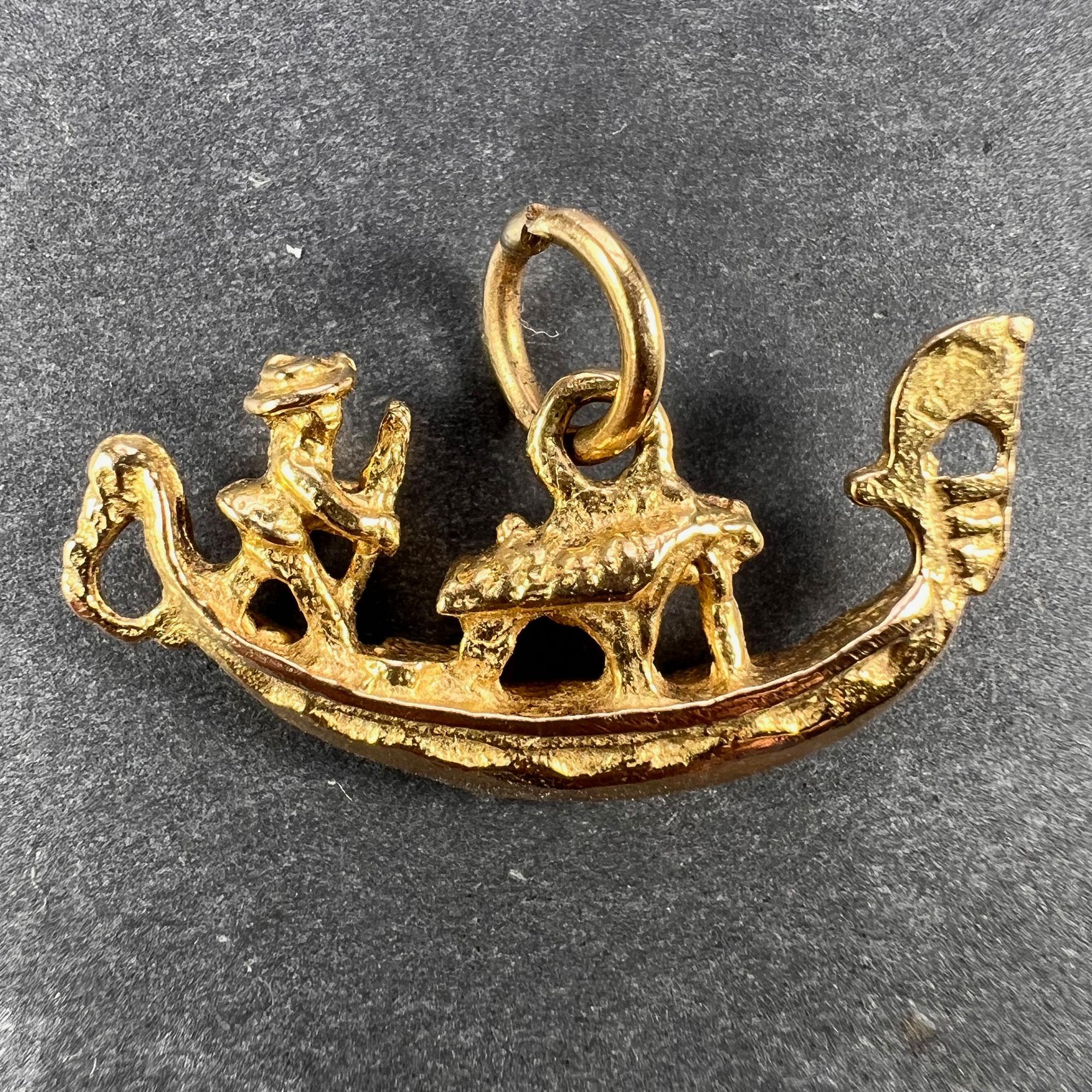 An Italian 18 karat (18K) yellow gold charm pendant designed as a gondola with white gold detail. Stamped 750 for 18 karat gold and marked 78VE for makers Caporin Renato & Bianchi Angelo SDF.

Dimensions: 1.2 x 2.5 x 0.45 cm (not including jump