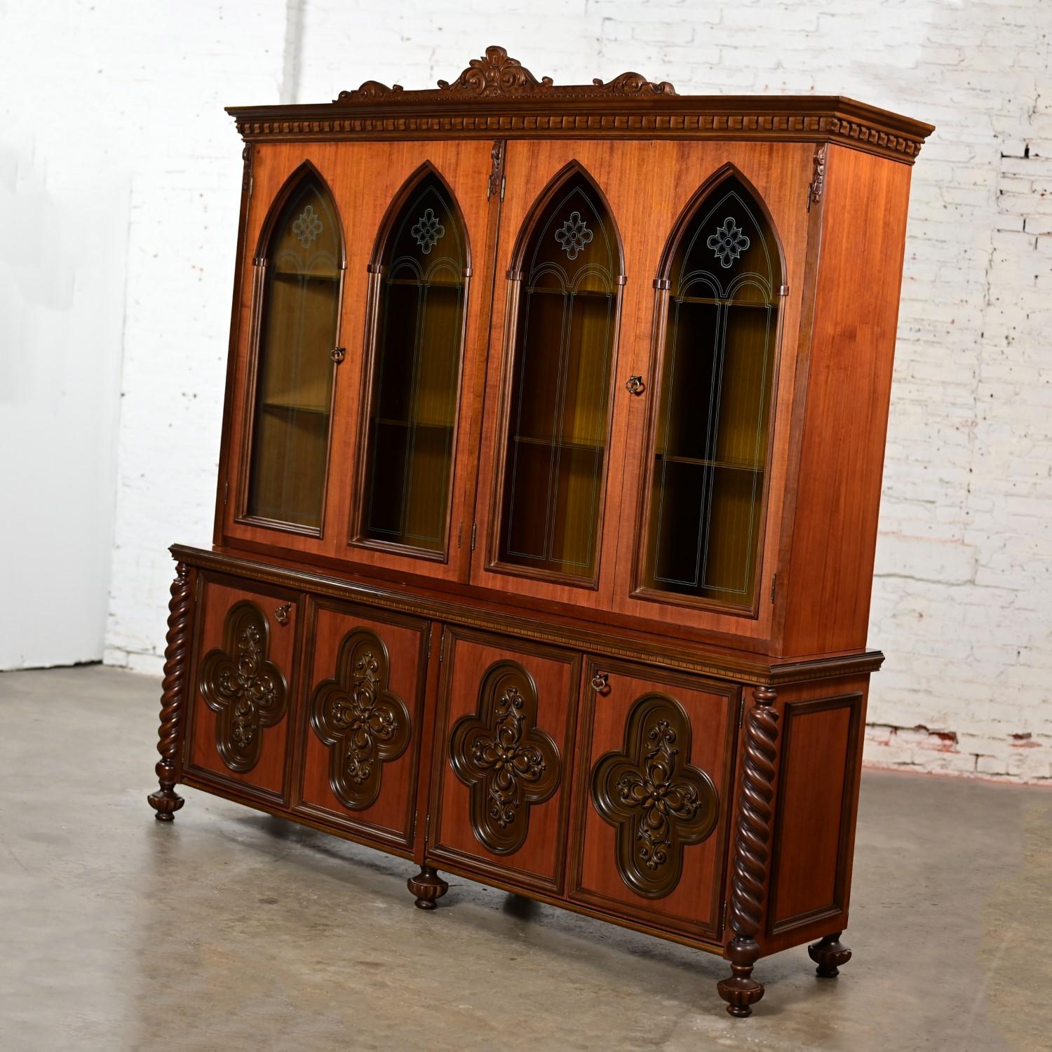 Magnificent 1960’s Italian Gothic Revival walnut toned wood and glass extra-large bookcase or display cabinet with plastic accents. Comprised of 2 pieces, a top hutch with glass shelves & wood trim details, gothic arched glass door fronts, & locks