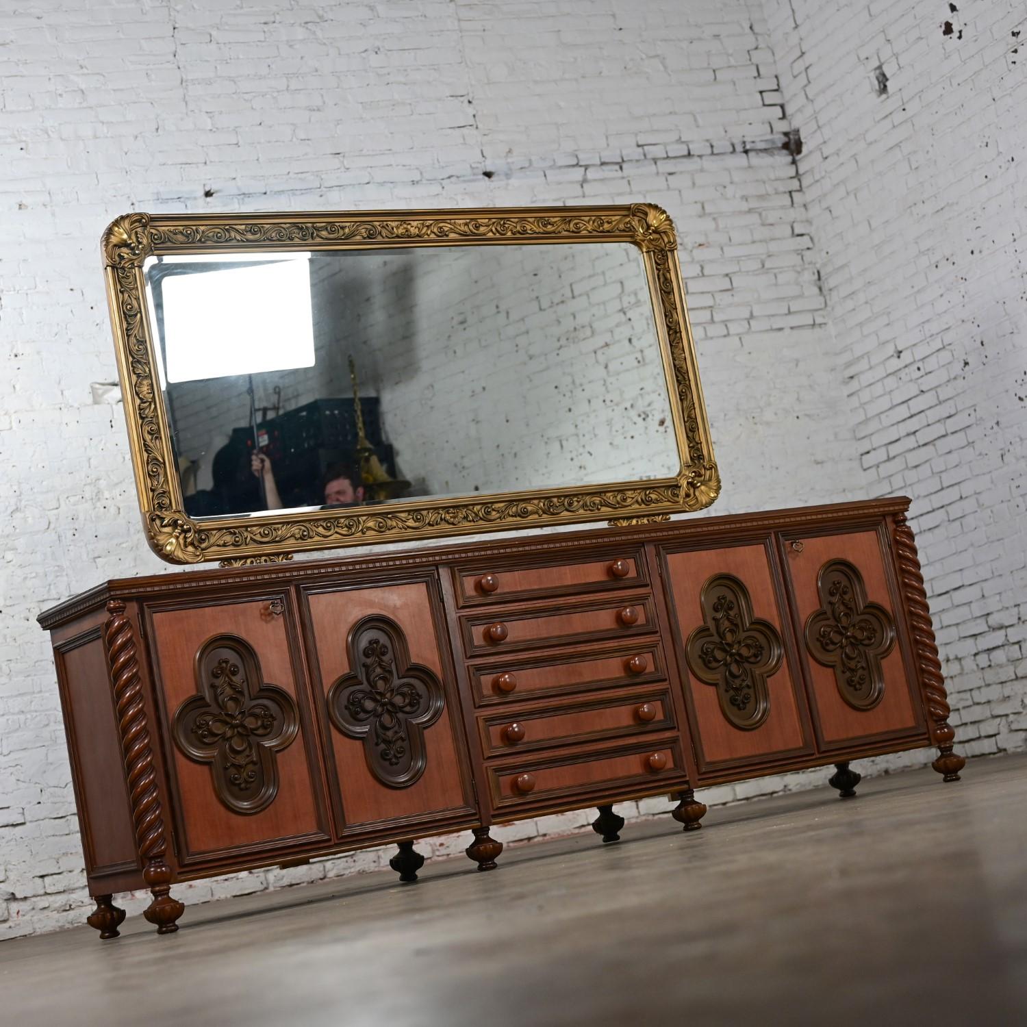 Stunning 1960’s Italian Gothic Revival wood and plastic accent buffet or sideboard with plastic barley twist legs, plastic gothic door front details, adjustable wood shelf behind the double doors on each side, brass skeleton keys, five center