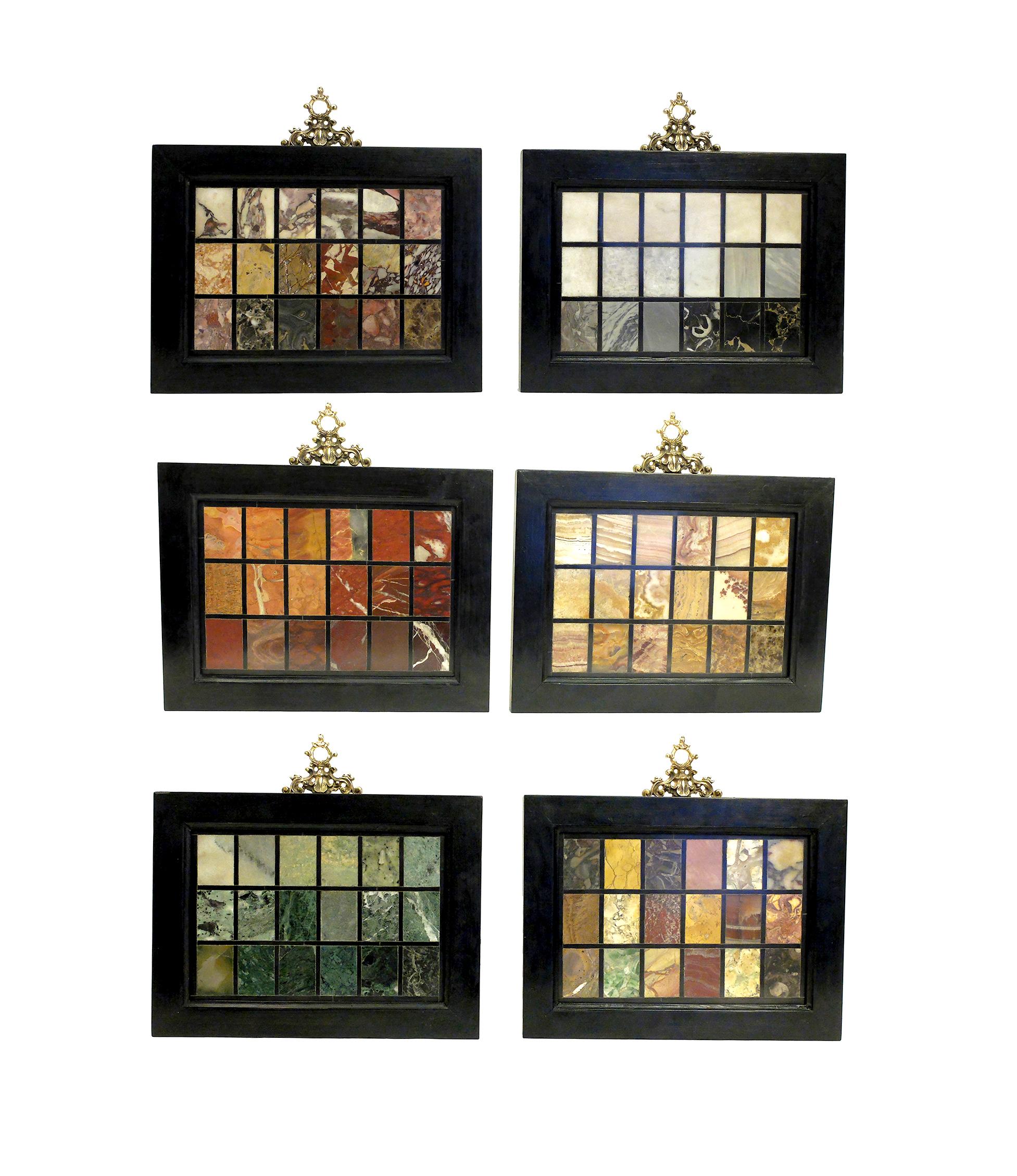 An Italian selection of six displays of marbles as samples of Grand Tour, mounted with ebonized wooden frames with gold gilded brass frieze. Verona, Italy, circa 1850.